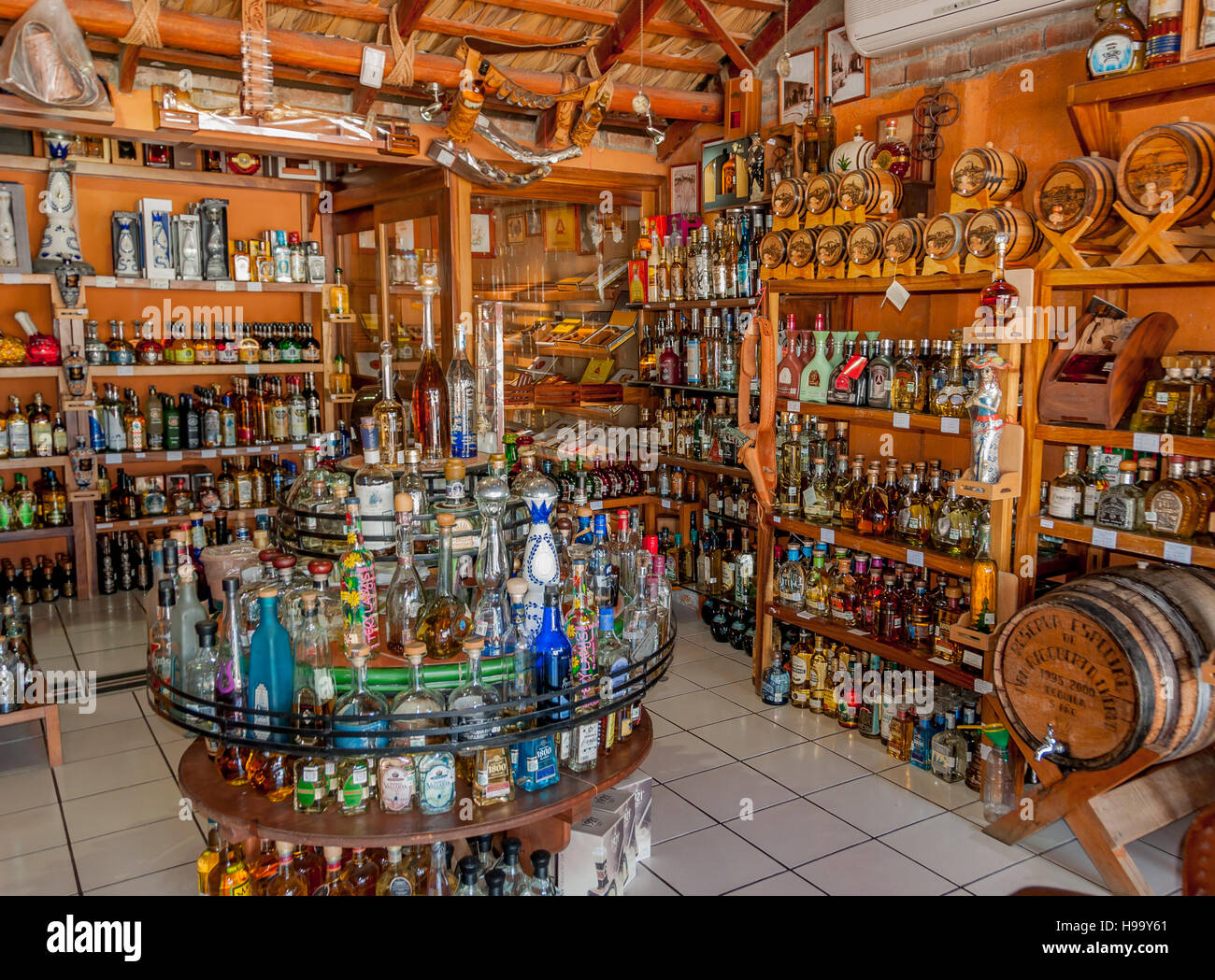 Tequila bottles and barrels on display inside tequila shop in San Jose del Cabo Old Town, Los Cabos, Mexico, Stock Photo