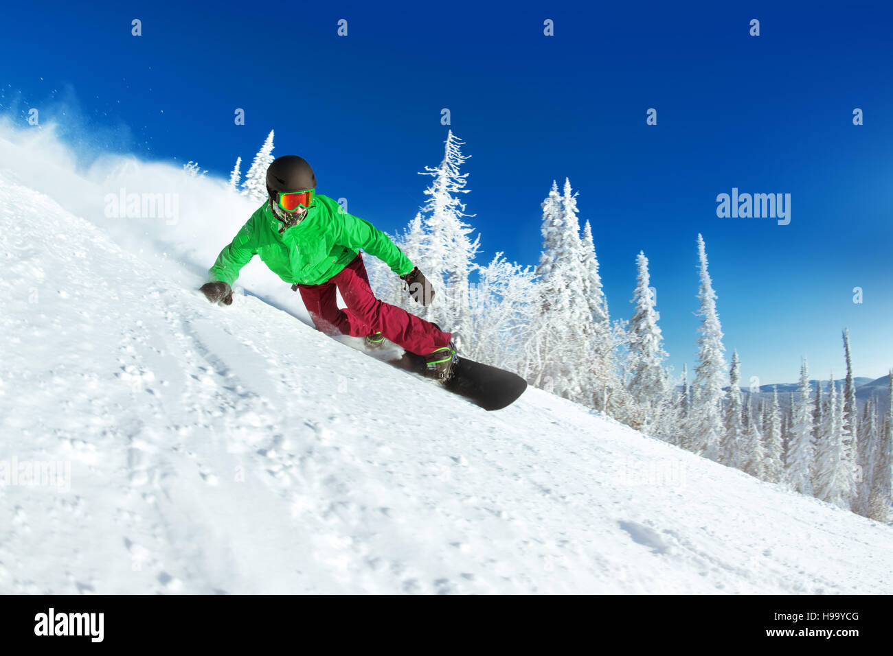Active snowboarder snowboarding rides closeup Stock Photo