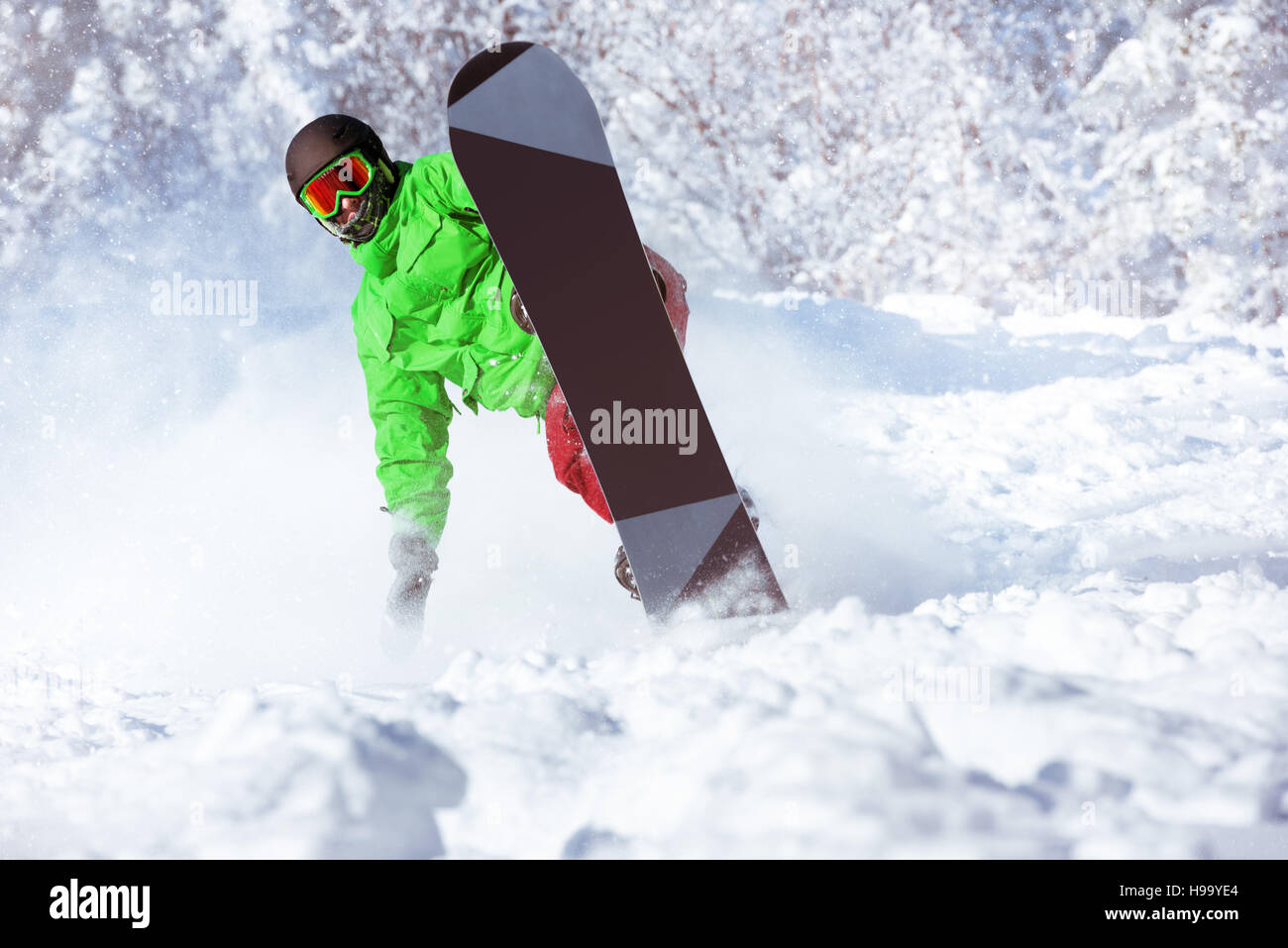 Active snowboarder rides in powder Stock Photo