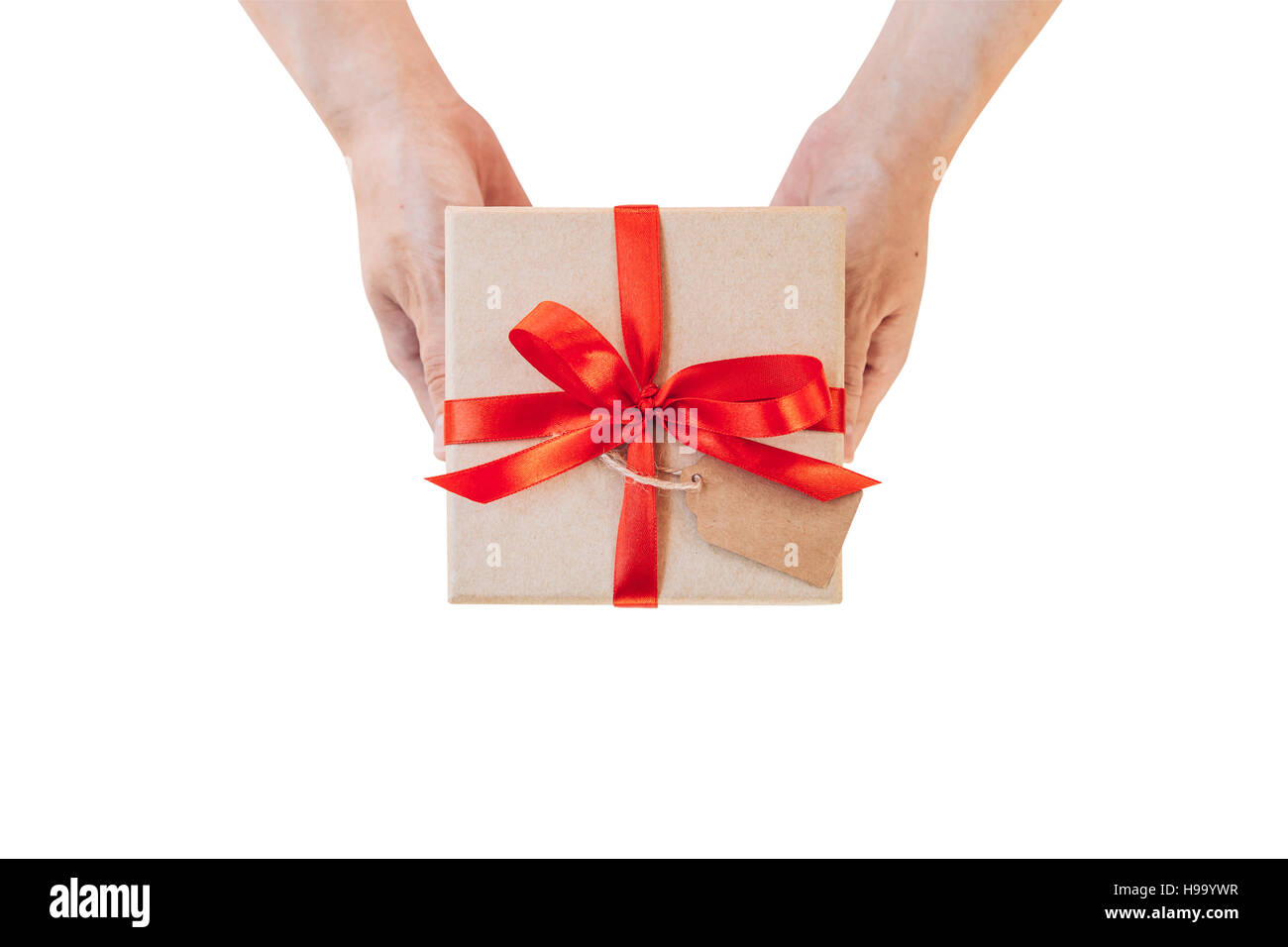 Hand woman holding gift box on isolated with clipping path. Image of christmas gift with red bow placed on female hand isolated white. Stock Photo