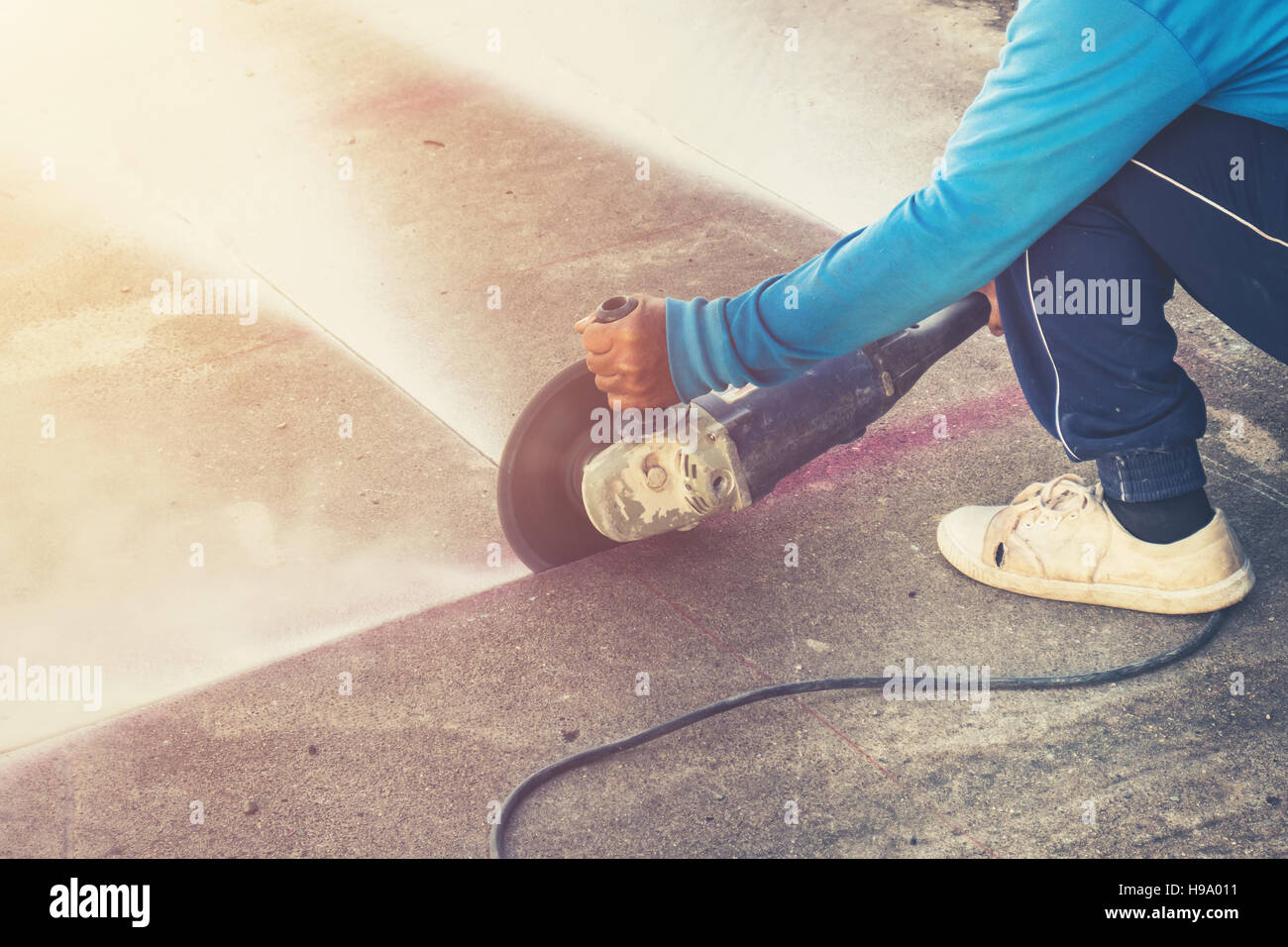Close up hand man cutting concrete floor with machine Stock Photo - Alamy