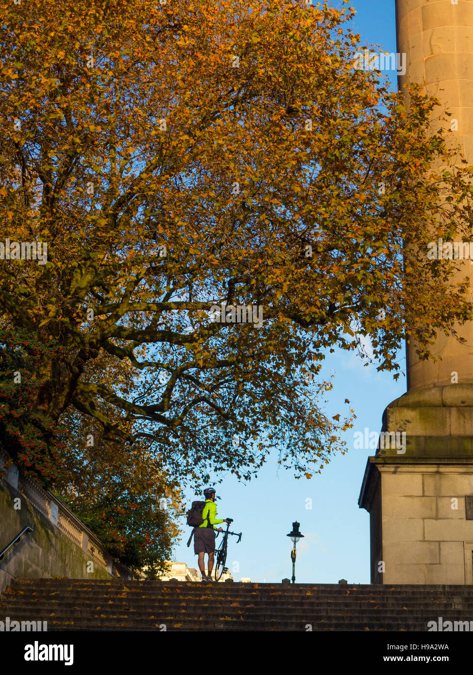Carrying a bike up steps in London Stock Photo Alamy