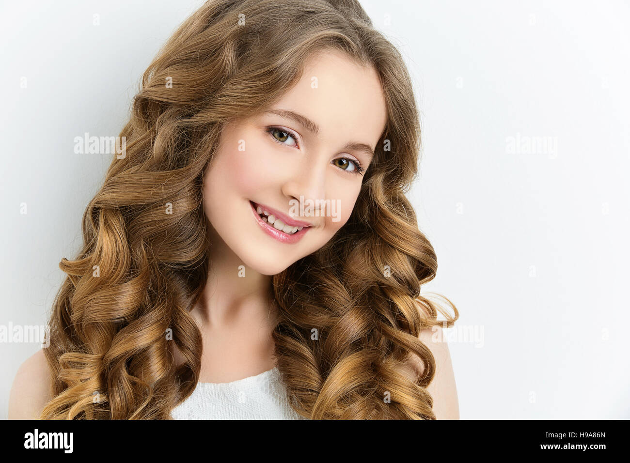 Girl with long curly hair Stock Photo - Alamy