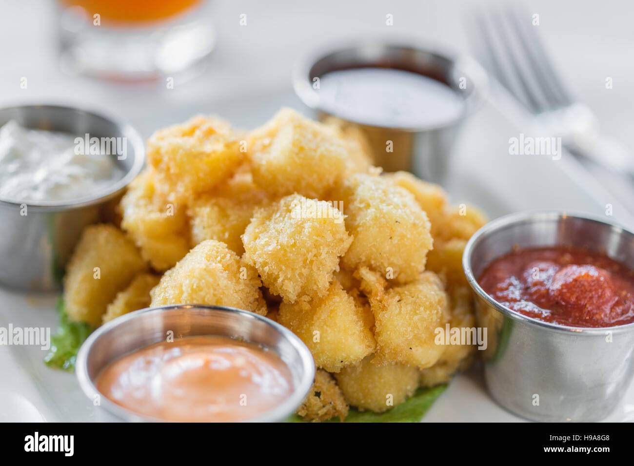 A fried cheese appetizer with various dipping sauces Stock Photo Alamy