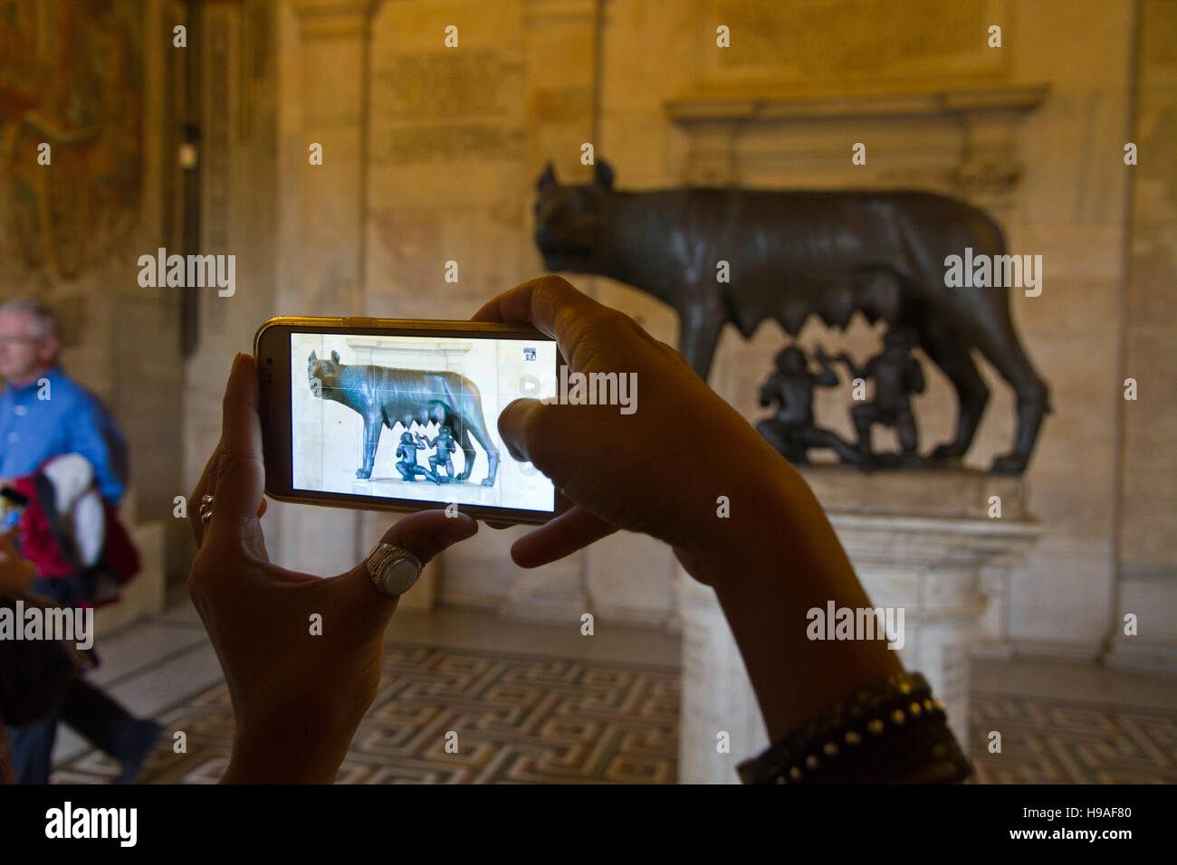 Capitoline Wolf statue, tourist shotting photos mobile Rome, italy, capitoline museums, musei capitolini, art touristic landmark Stock Photo