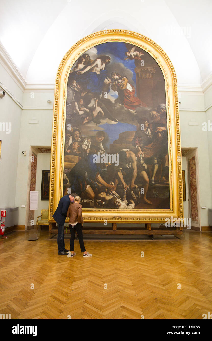 Couple looking a big painted classic arts in Rome italy, capitoline