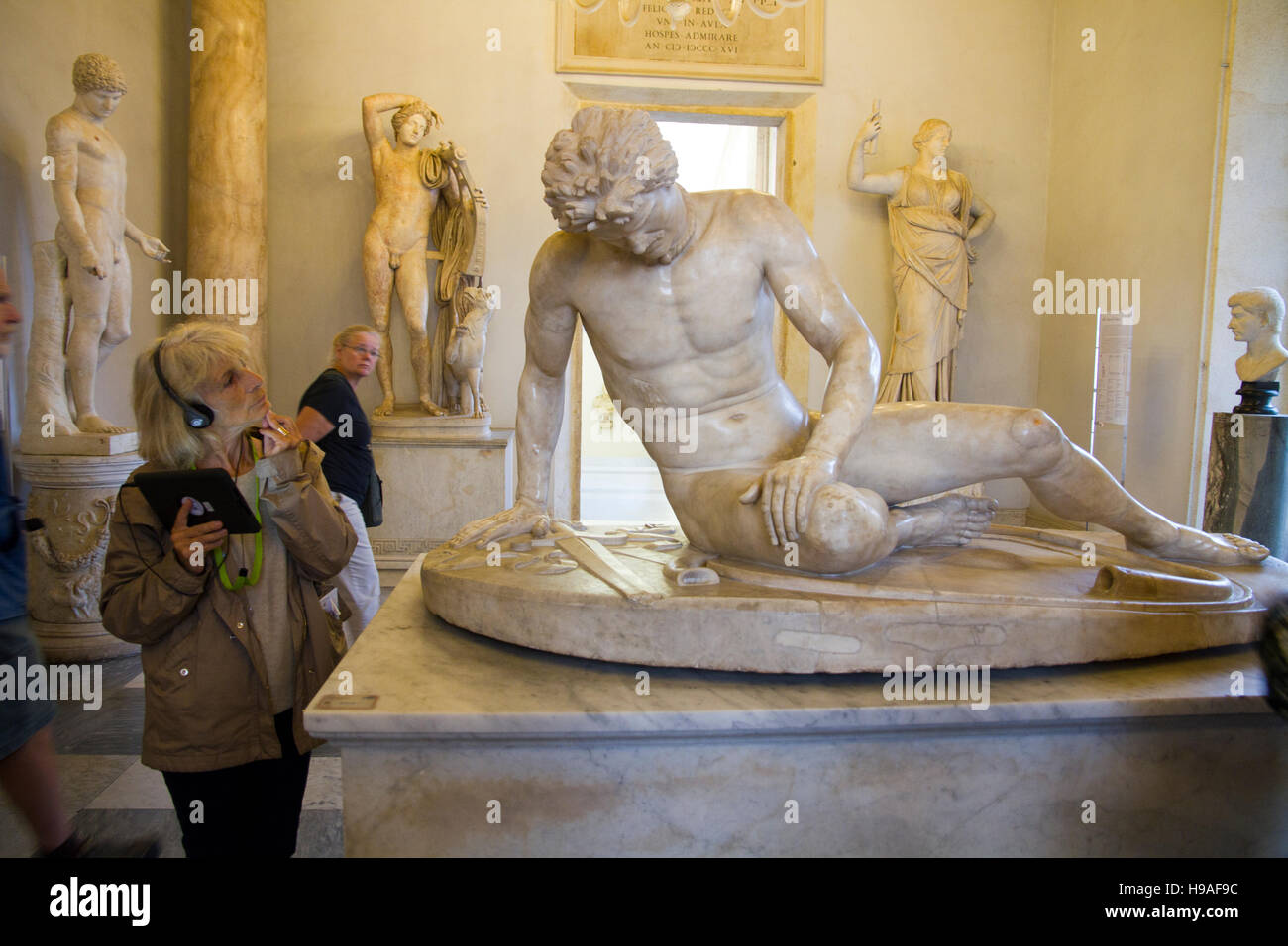Woman tourist looking statue art scene Rome, italy, capitoline museums, musei capitolini, heritage touristic landmark Stock Photo