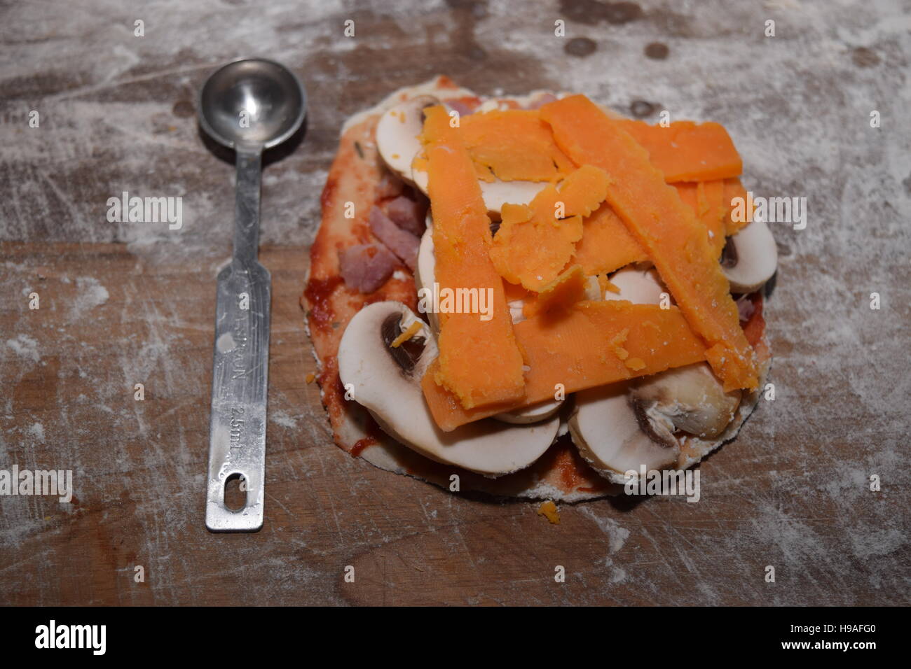Small uncooked pizza in a kitchen Stock Photo Alamy