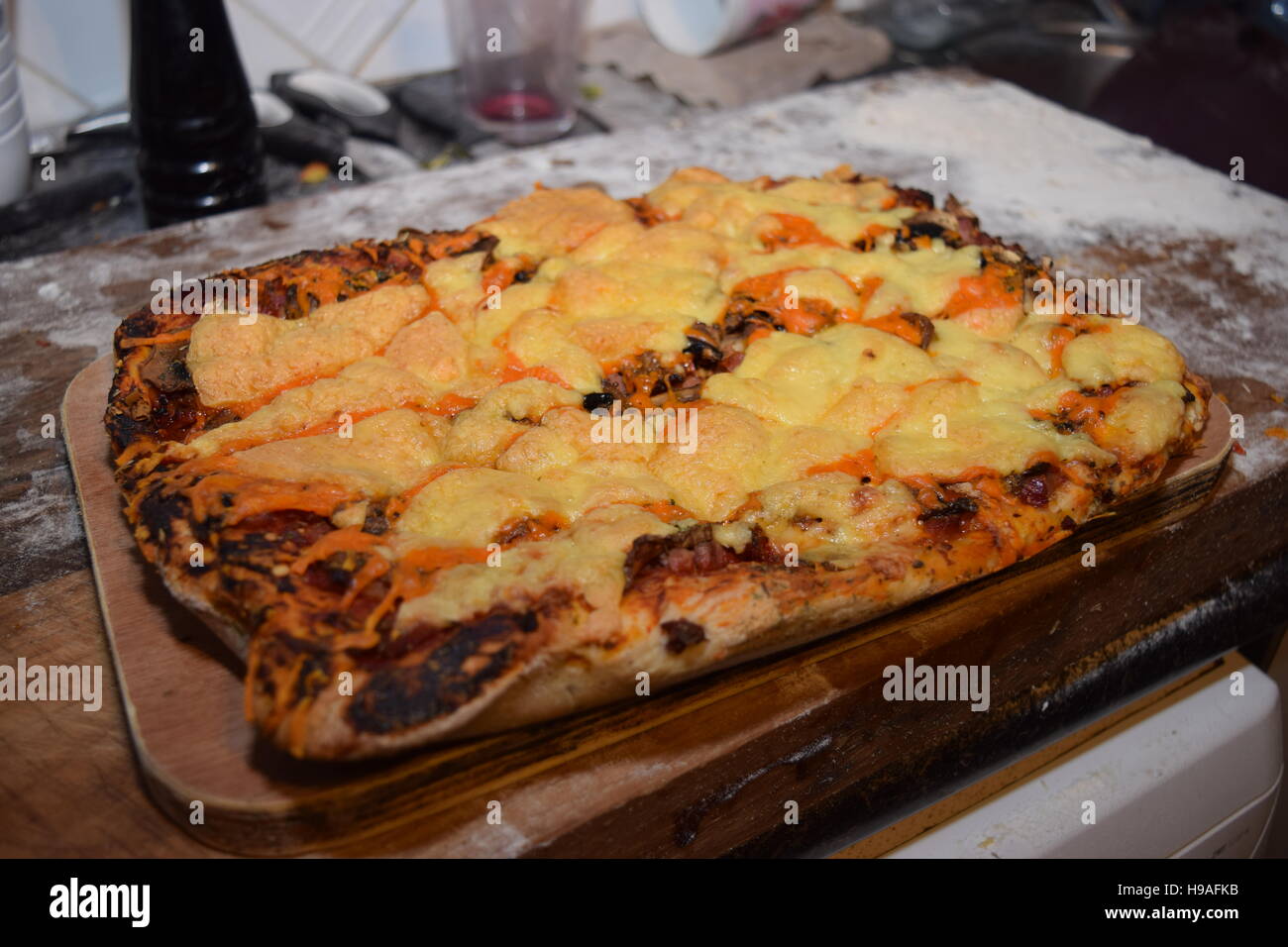 Homemade rectangular pepperoni pizza on a rustic table Stock Photo - Alamy