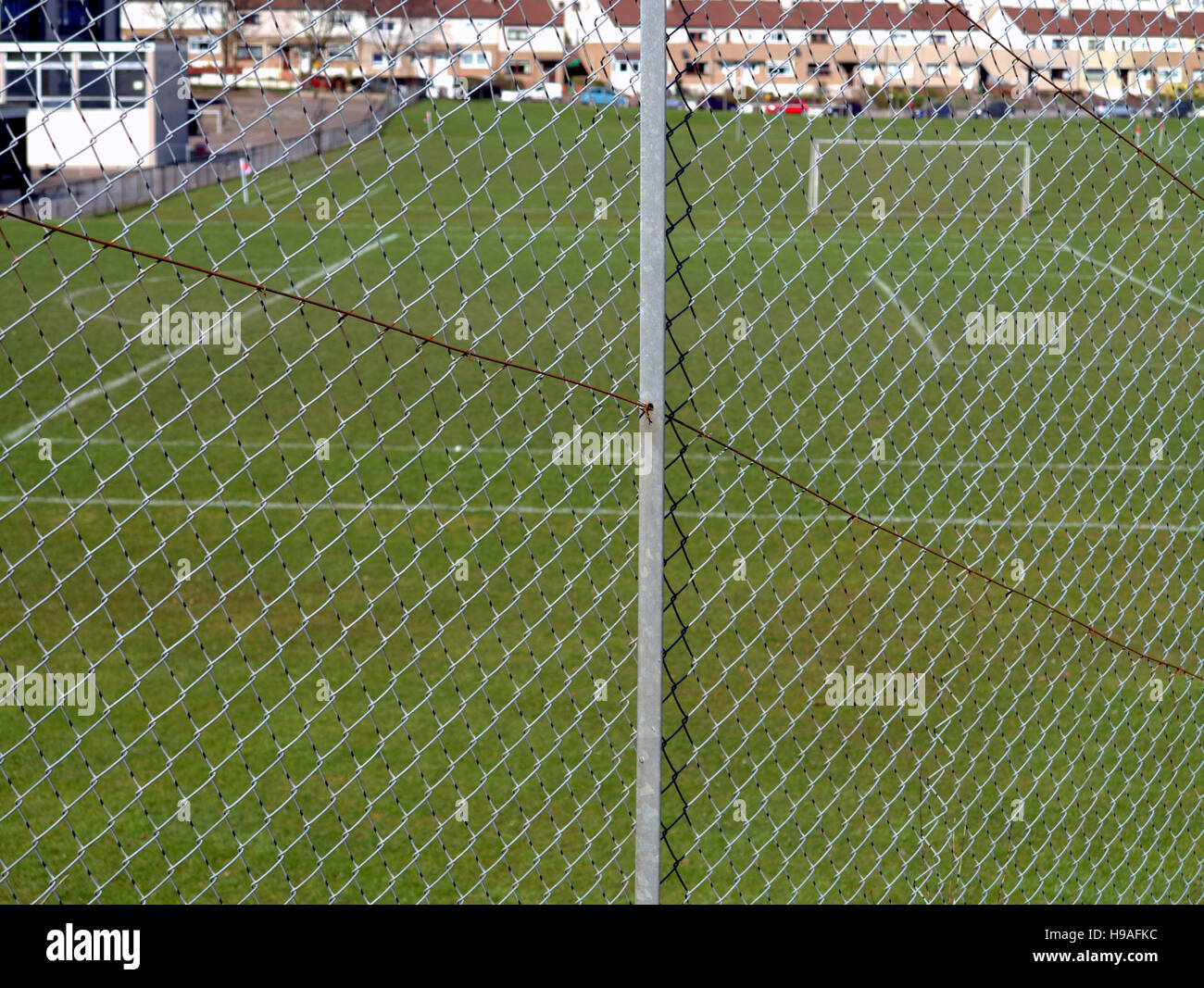 school football soccer  pitch shot through wire cage Stock Photo