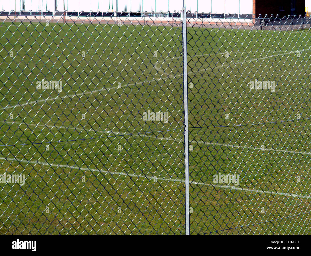 school football soccer  pitch shot through wire cage Stock Photo