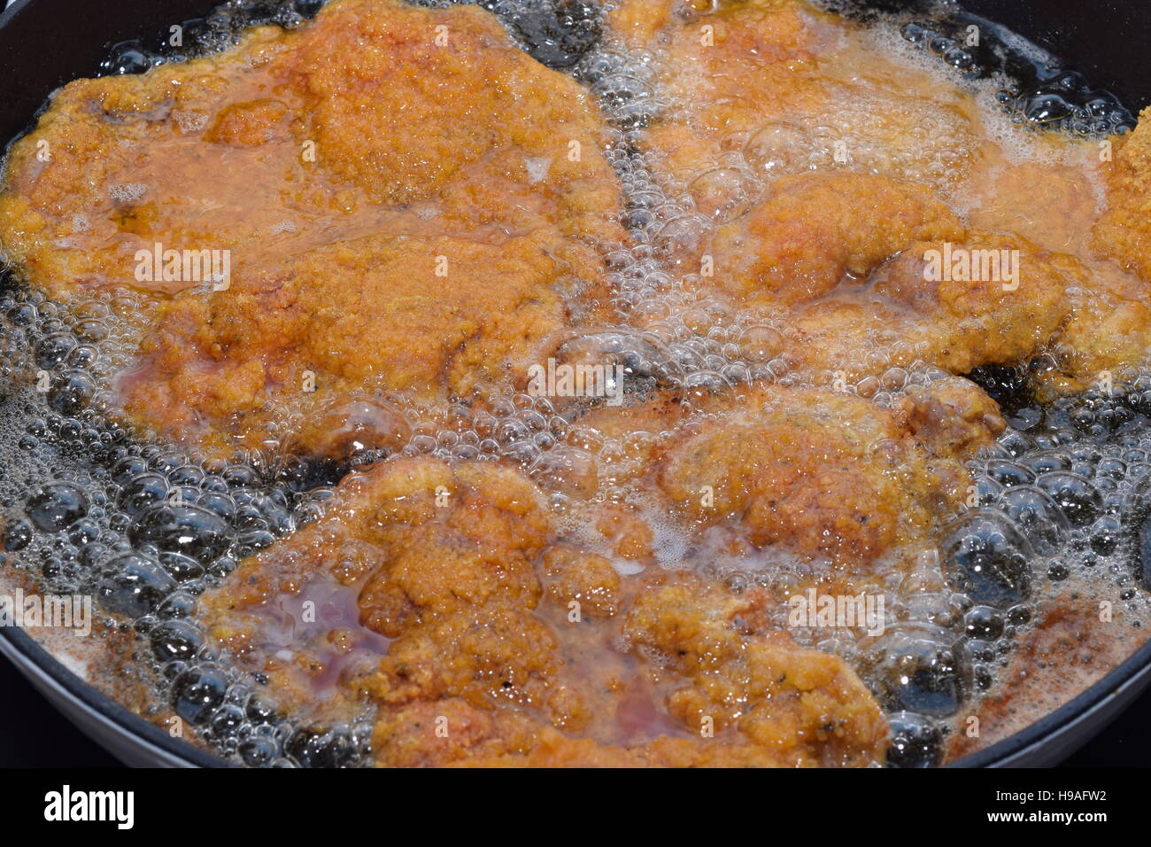 Wiener Schnitzel frying in an iron cast pan Stock Photo Alamy