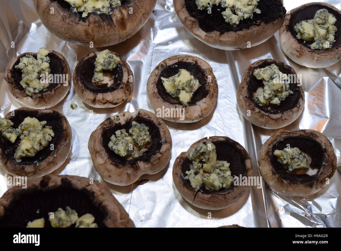 Mushrooms laid on tin foil ready for preparation Stock Photo Alamy