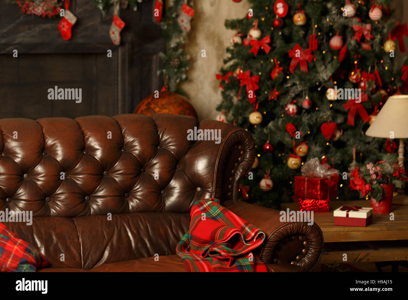 Atmospheric Christmas background with a warm blanket and a Christmas tree. Homeliness. Stock Photo