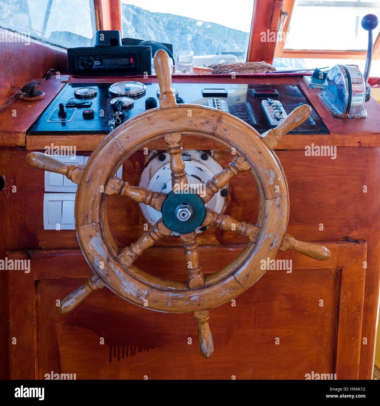 Ship's cabin with instruments and wooden wheel Stock Photo