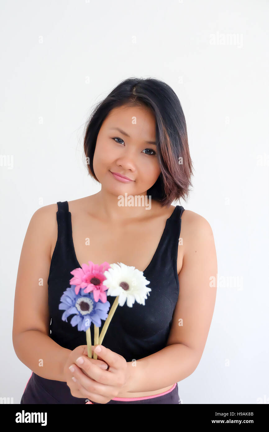Asian woman on white background, holdnig flowers Stock Photo