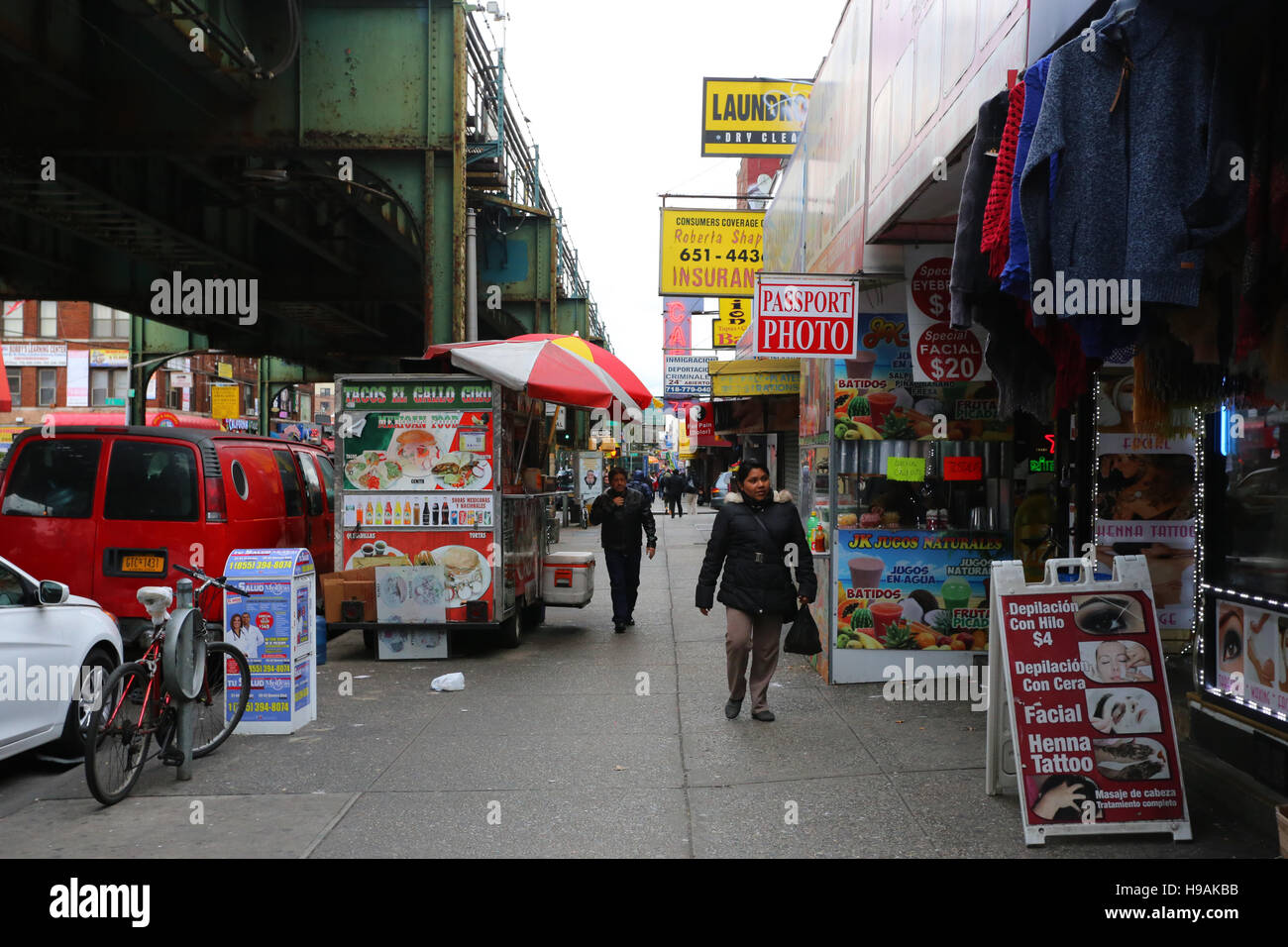 People walking along the main thoroughfare of Roosevelt Avenue in the