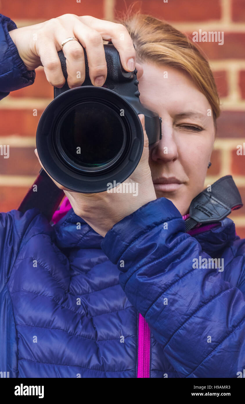 Portrait of a professional female photographer with a camera Stock Photo