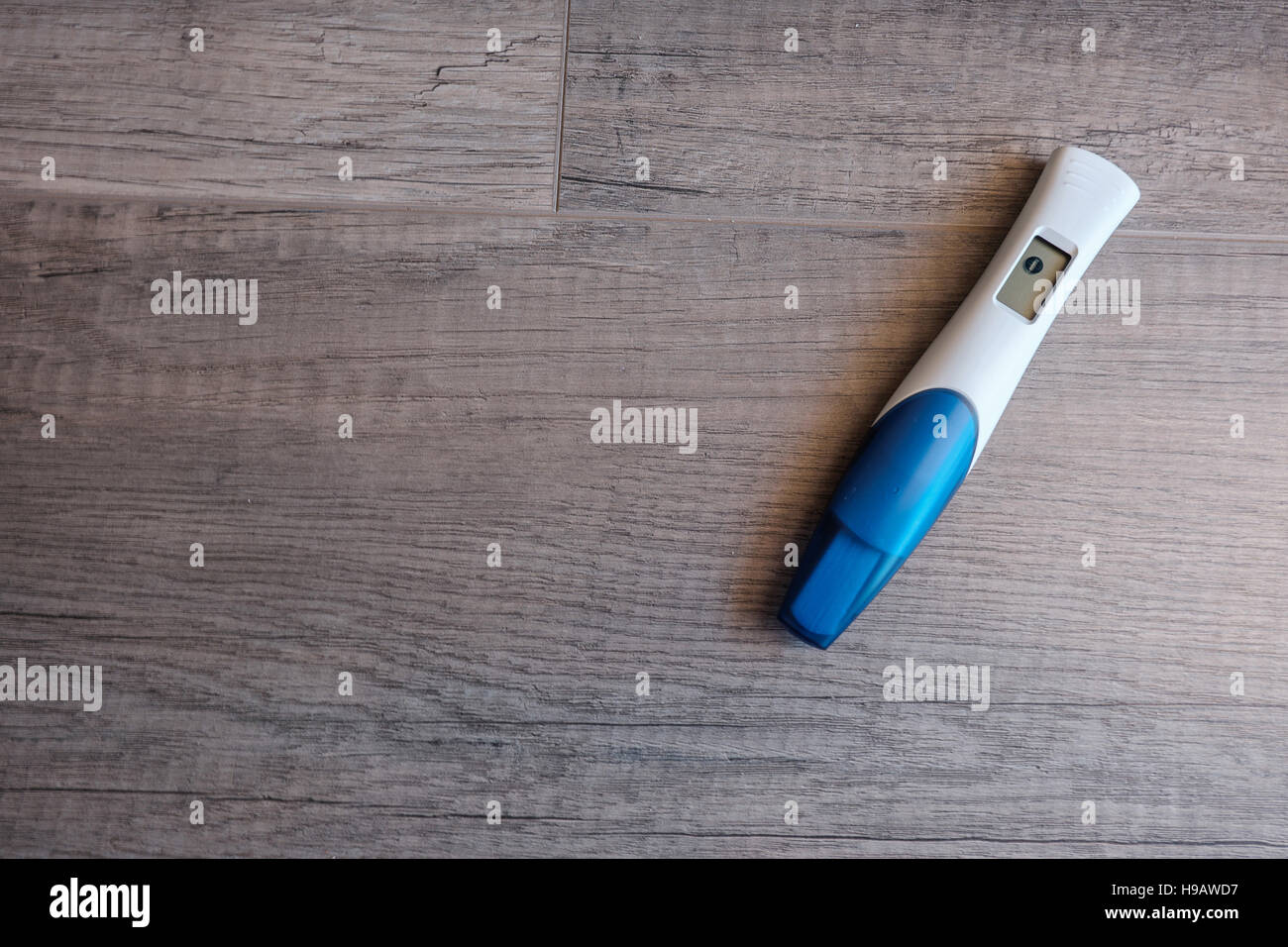 Digital pregnancy test with negative result on wooden background Stock Photo