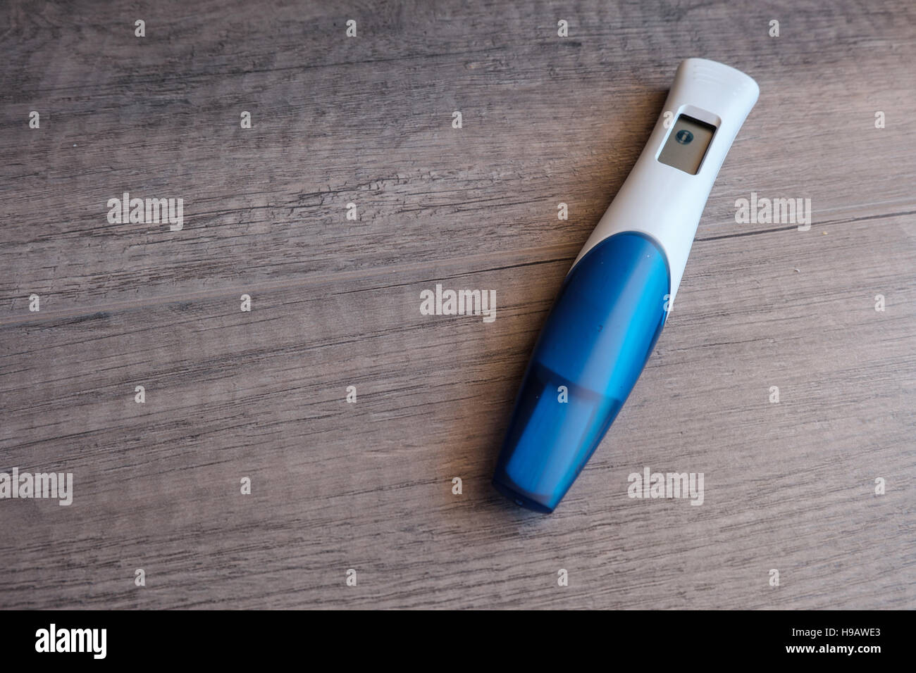 Digital pregnancy test with negative result on wooden background Stock Photo