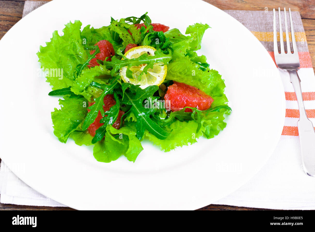 Salad with Mix Batavian, Frise, Radicchio, Chicory, Arugula and Grapefruit Studio Photo Stock Photo