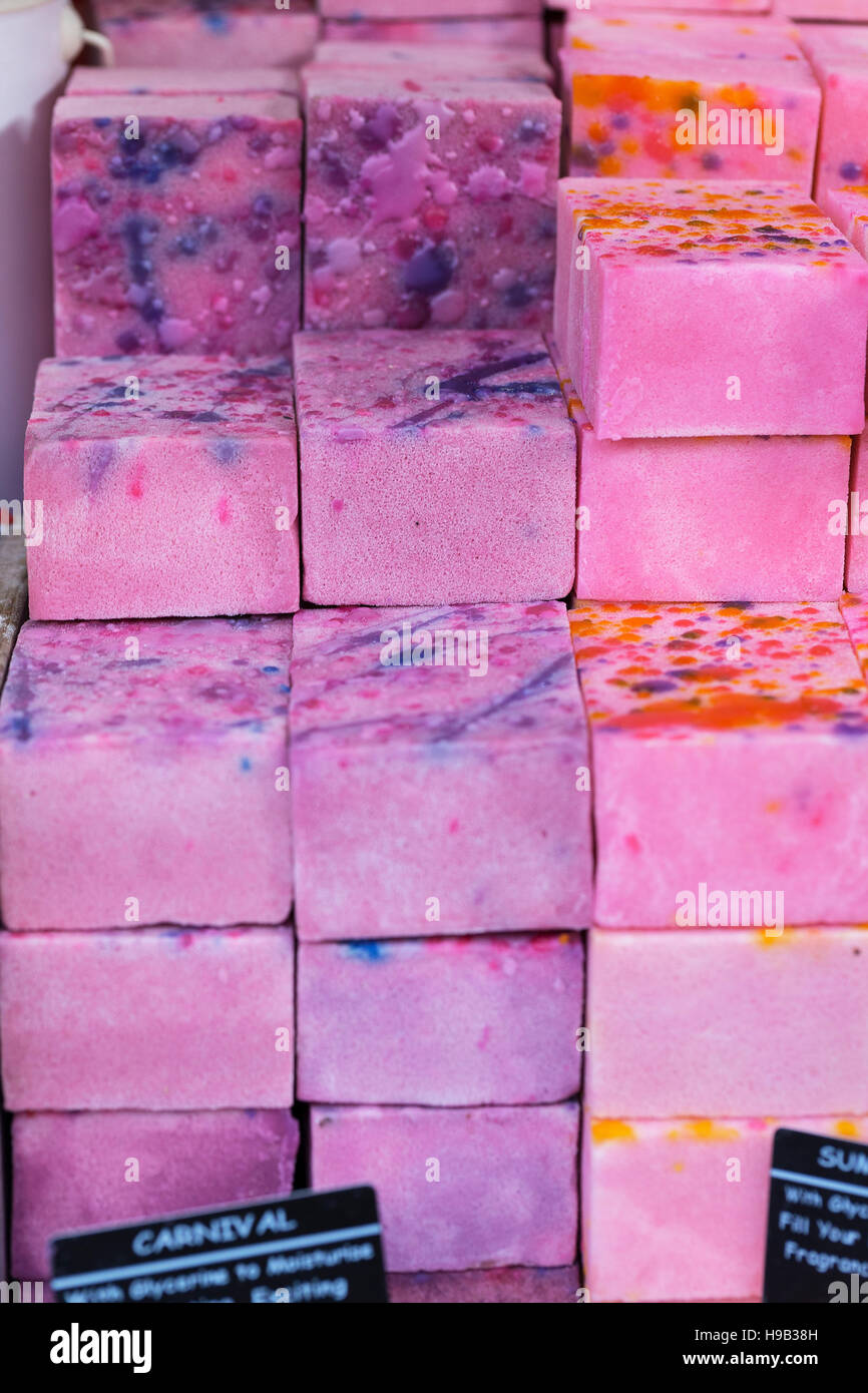 Colorful pink and purple marbled blocks of handmade soap on stall at craft market Stock Photo