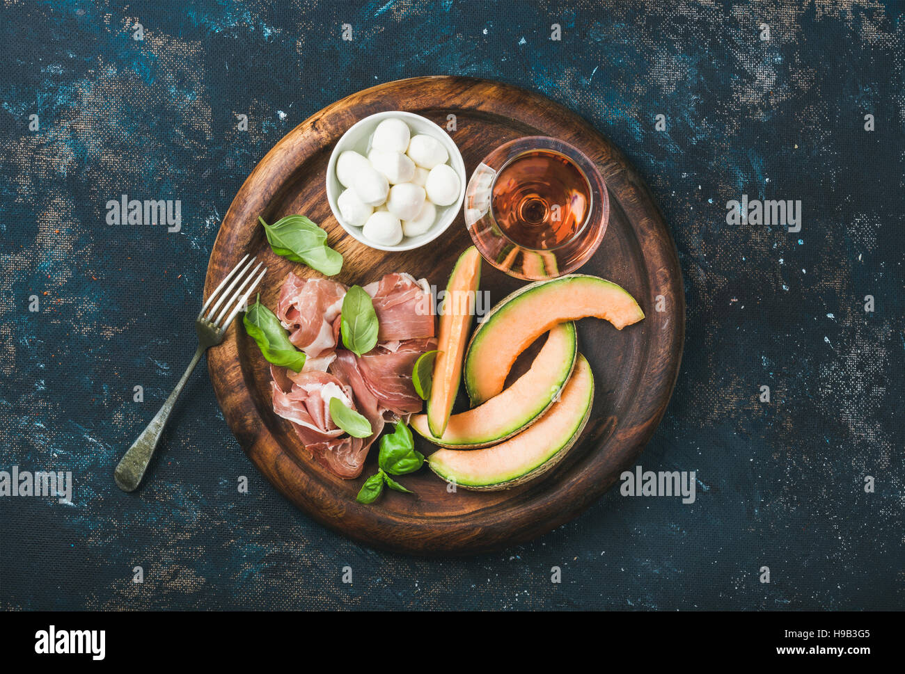Prosciutto, cantaloupe melon, basil, mozzarella and glass of rose wine