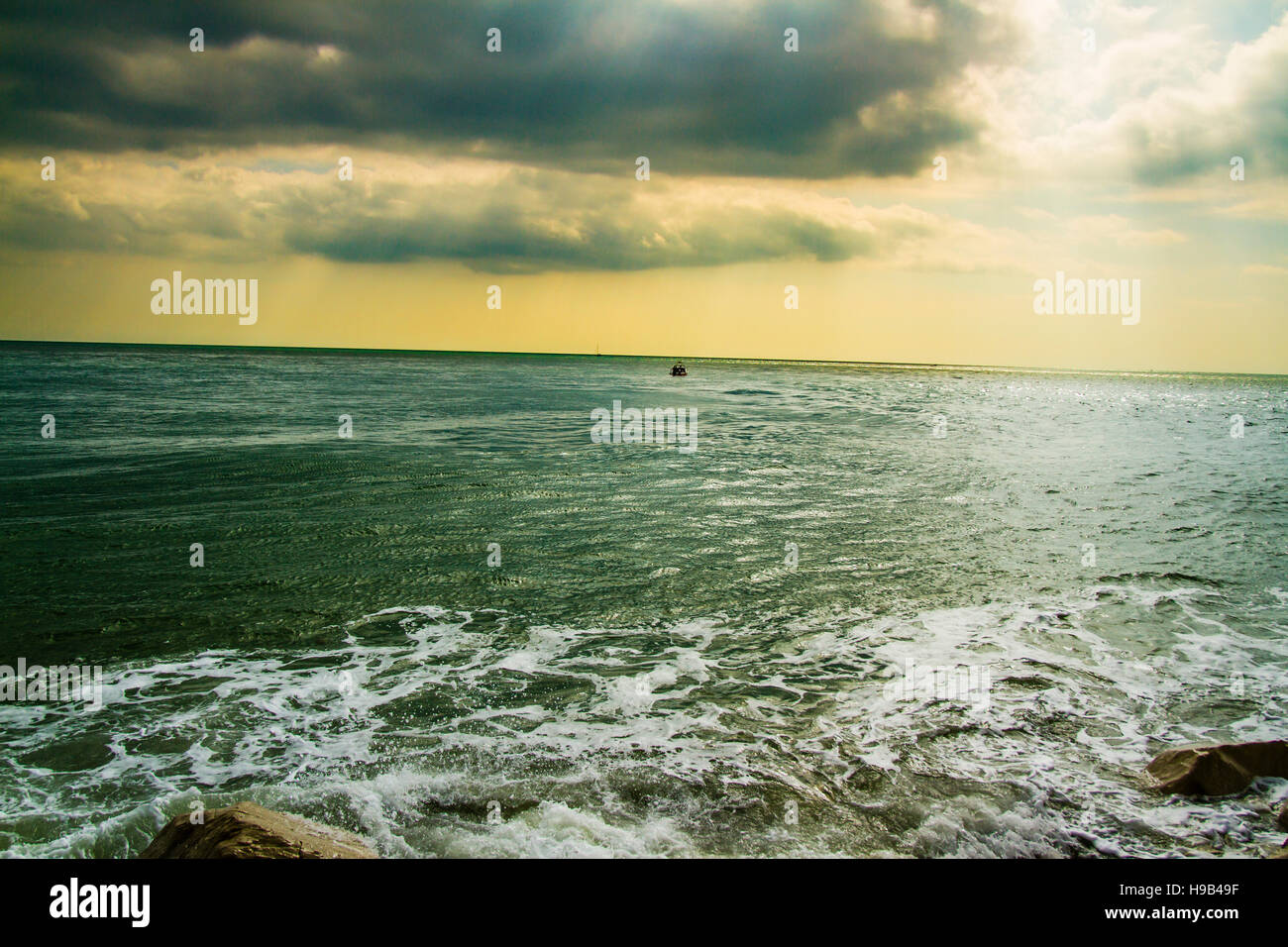 Sun through storm clouds over the sea hi-res stock photography and ...