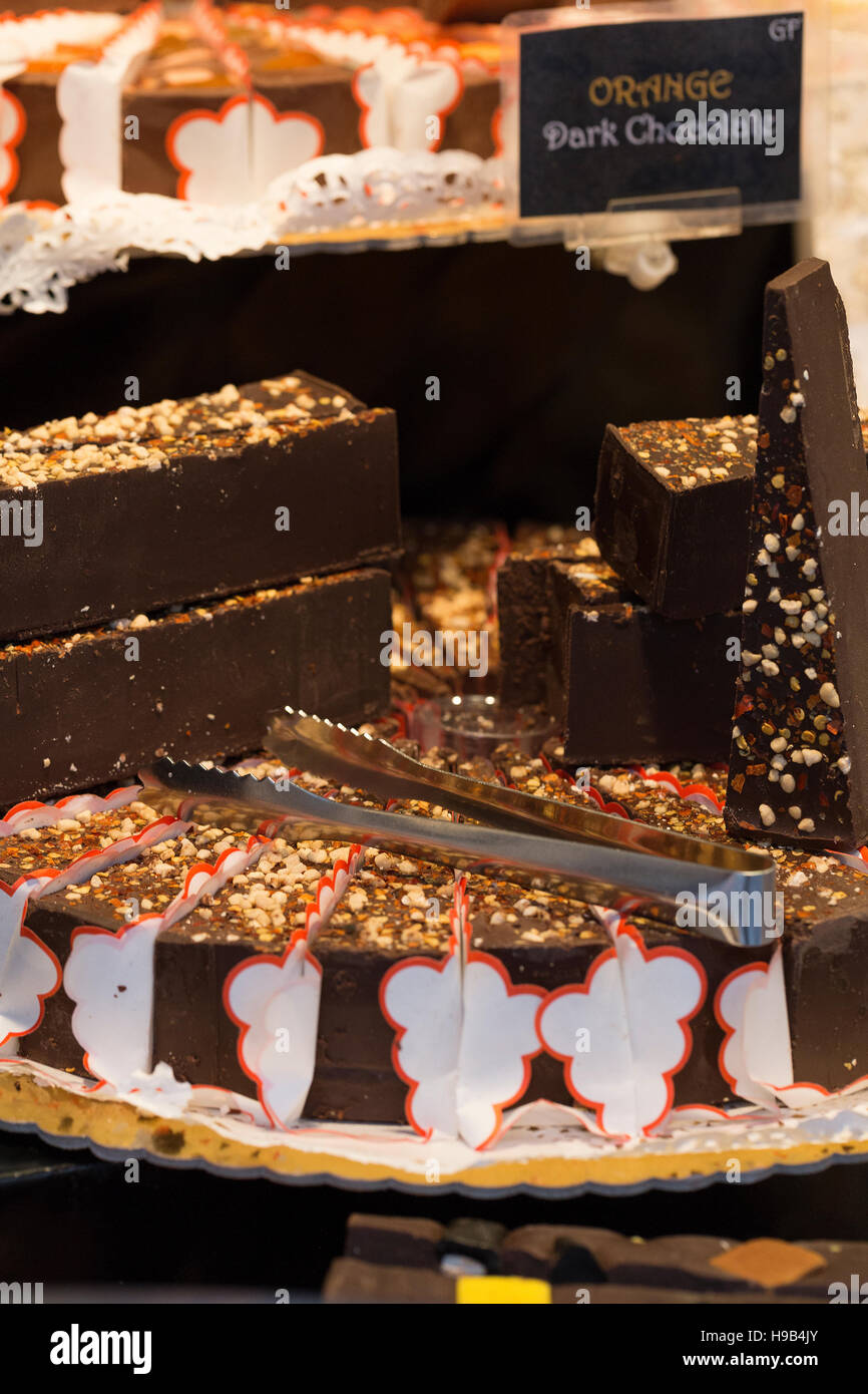 Close up artisan farmers market display of chocolate cream cheese cake