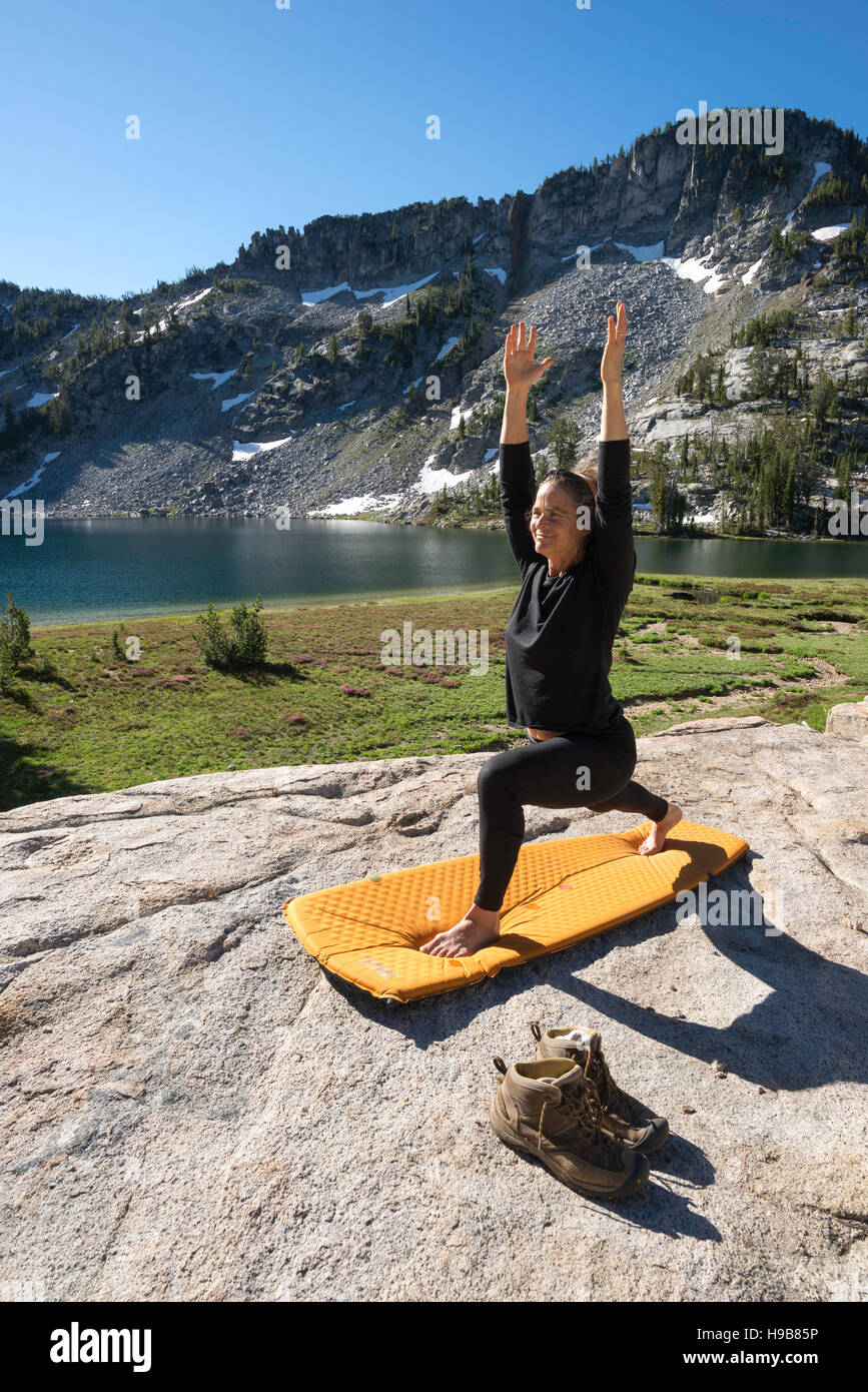 Backpacker doing yoga at a camp high in Oregon's Wallowa Mountains