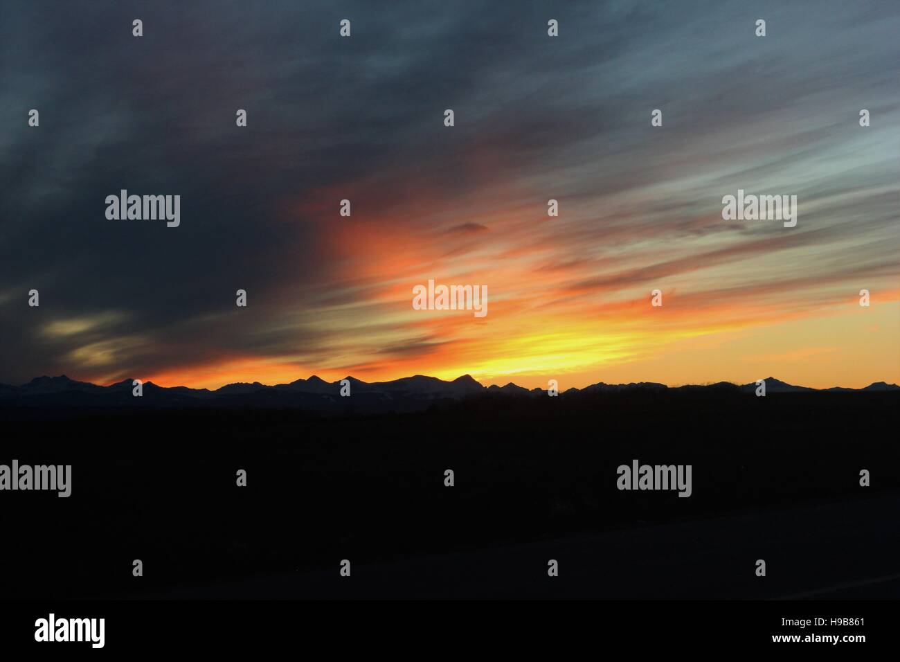 Sunset over the mountains Stock Photo - Alamy