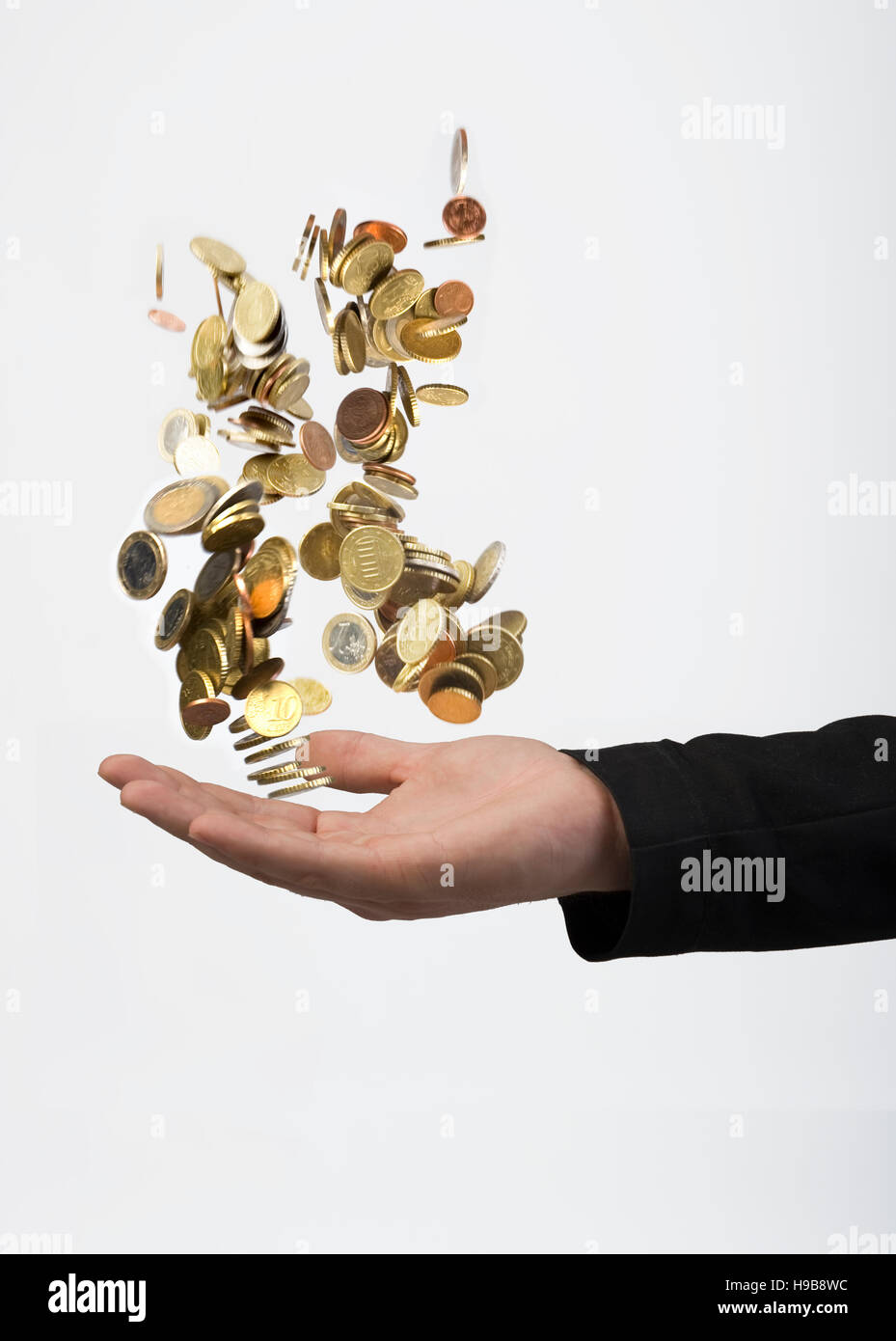 Hand throwing coins Stock Photo