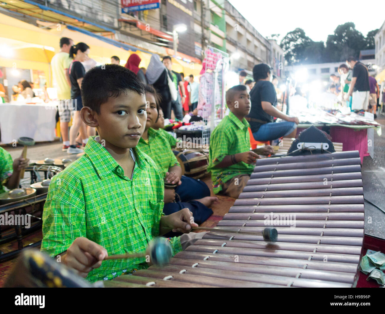 Group of children, Thais making music at the night market with ...