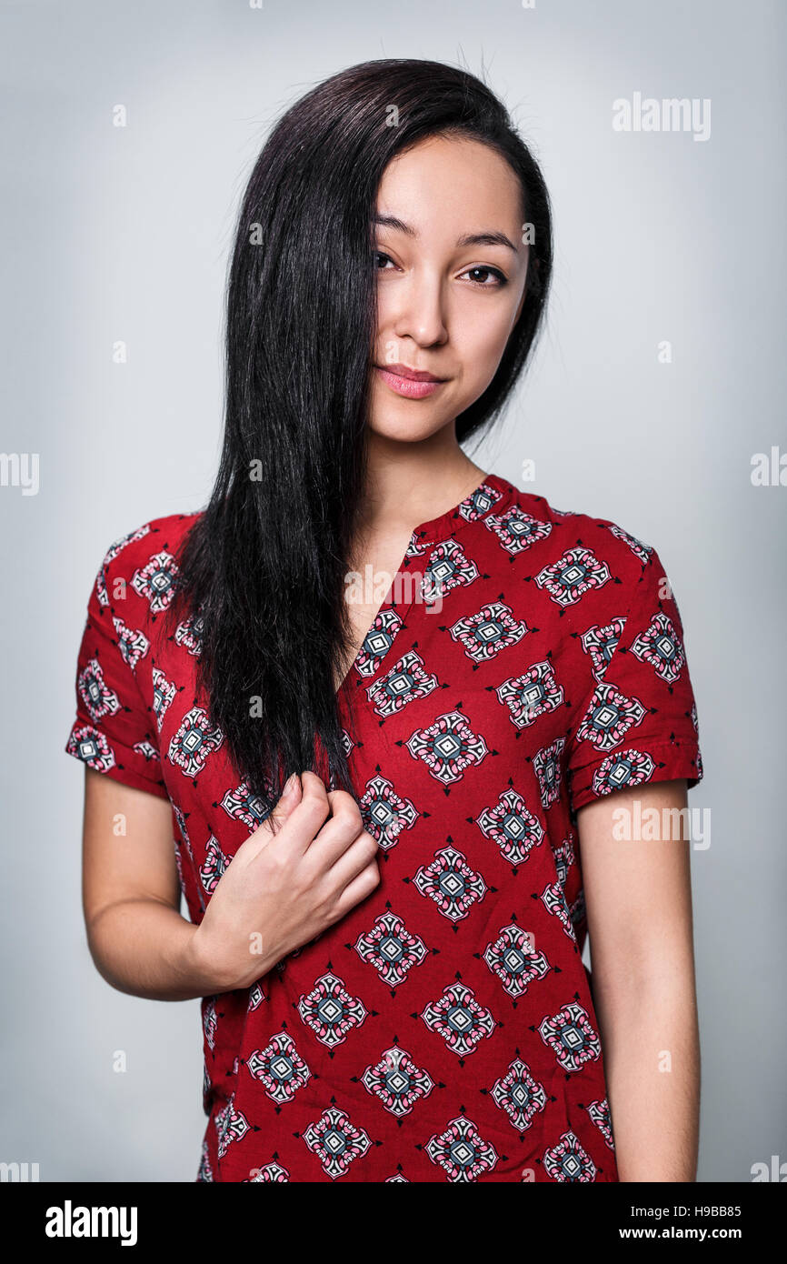 Young woman smiling with curly black hair Stock Photo