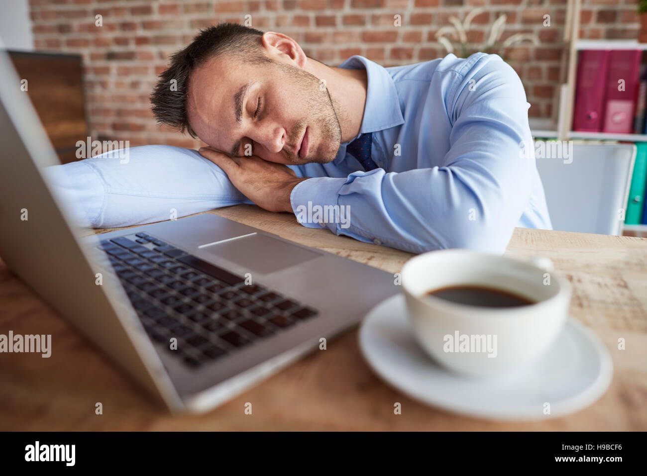 Man sleeping on the office desk Stock Photo