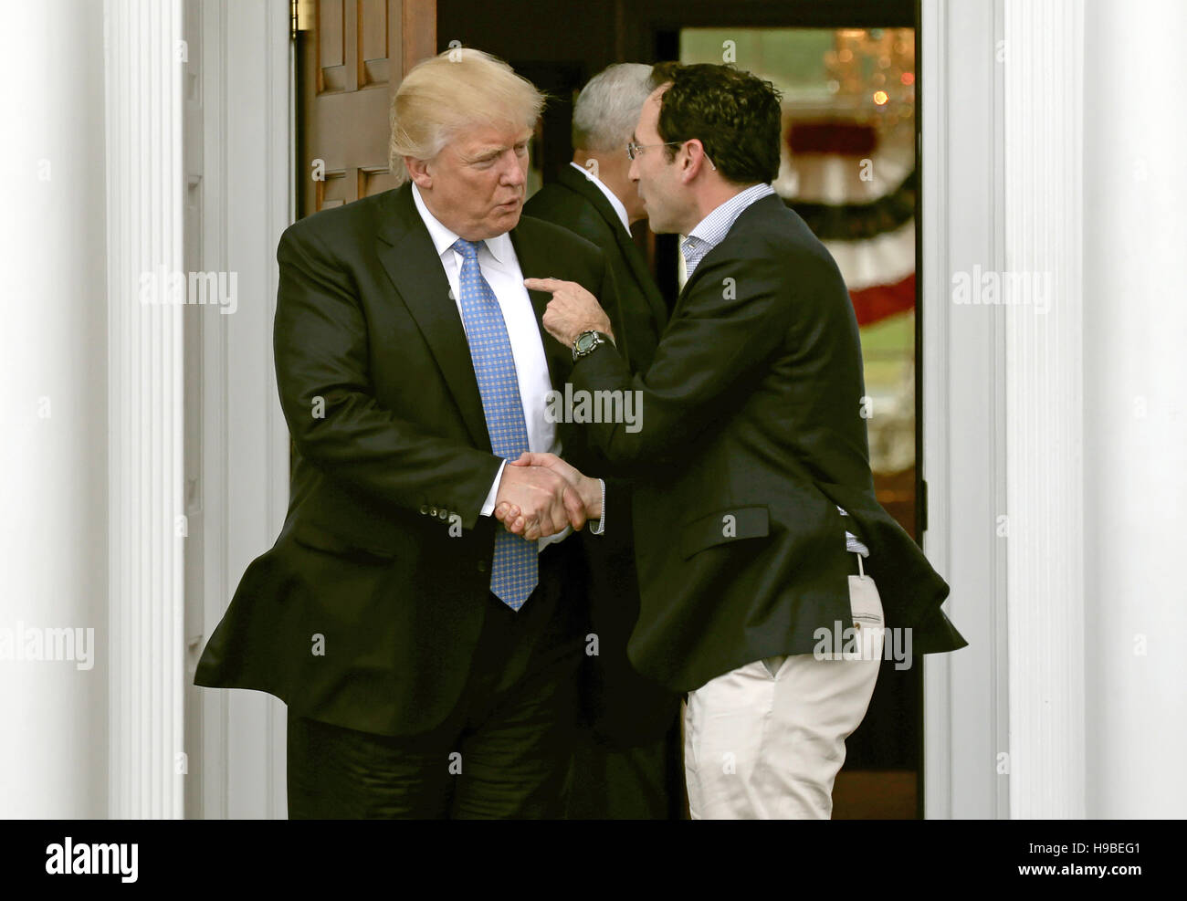 Bedminster Township, New Jersey, USA. 20th Nov, 2016. United States President-elect Donald Trump (L) shakes hands with Jonathan Gray at the clubhouse of Trump International Golf Club, in Bedminster Township, New Jersey, USA, 20 November 2016. Credit: Peter Foley/Pool via CNP - NO WIRE SERVICE - Credit:  dpa/Alamy Live News Stock Photo