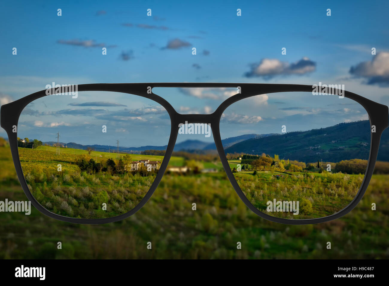 Clear image in glasses against blurry landscape Stock Photo