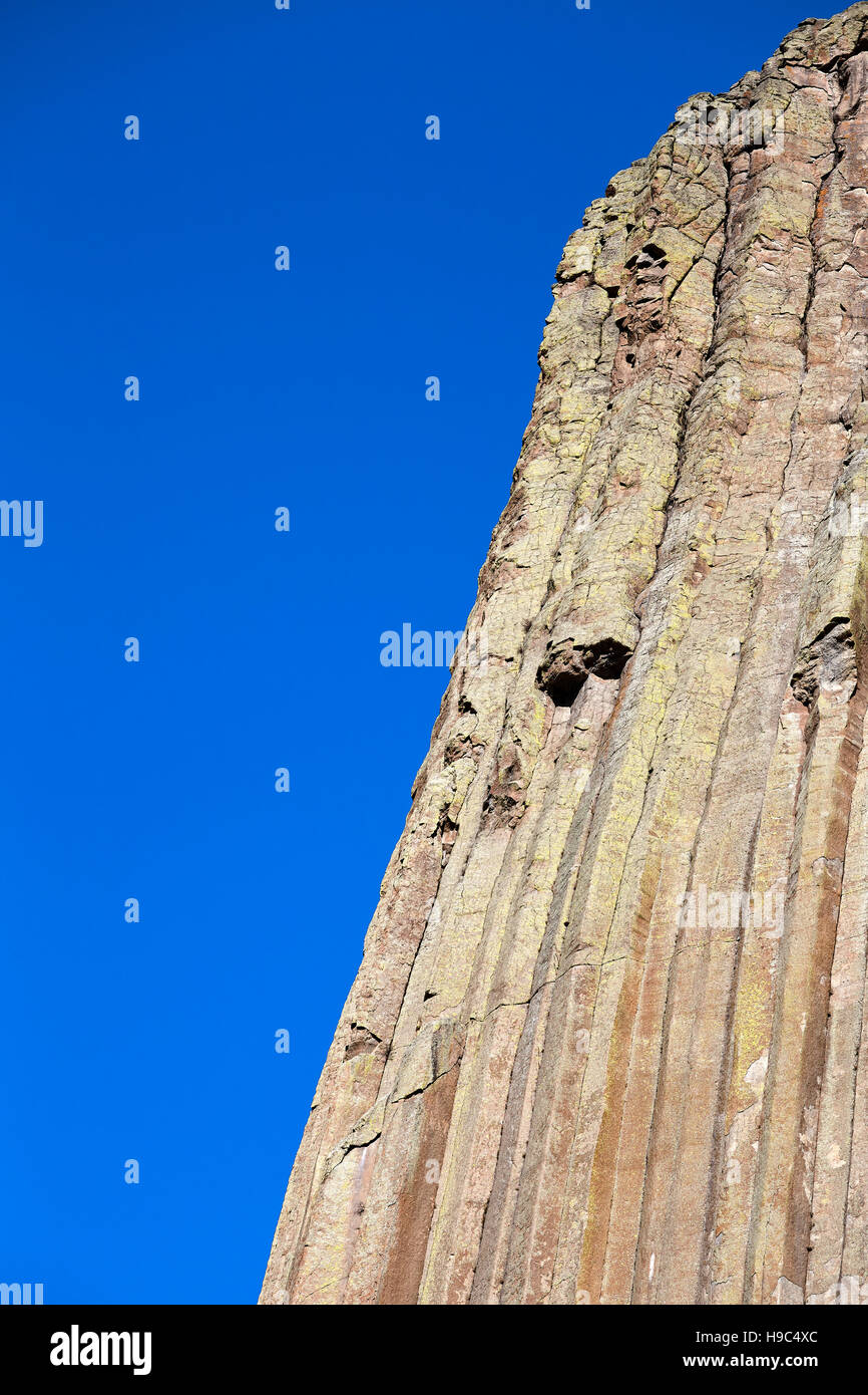 Devils Tower rock formations against blue sky, natural background, a laccolith butte composed of igneous rock in the Bear Lodge Mountains, USA. Stock Photo