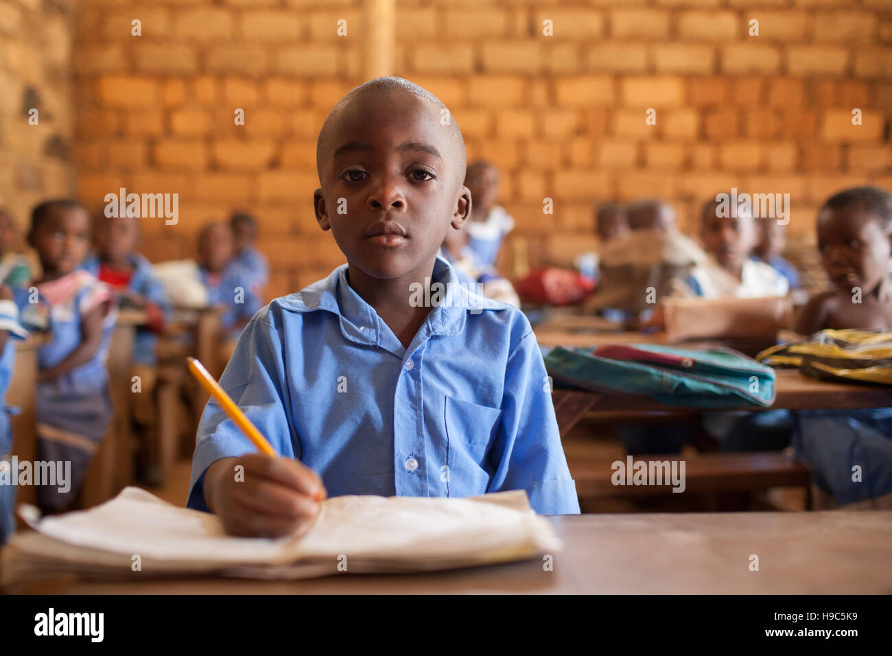 Young African school boy, 5-7 years old sitting in classroom Bambili Primary School, near Bamenda, Cameroon North West Africa. Stock Photo