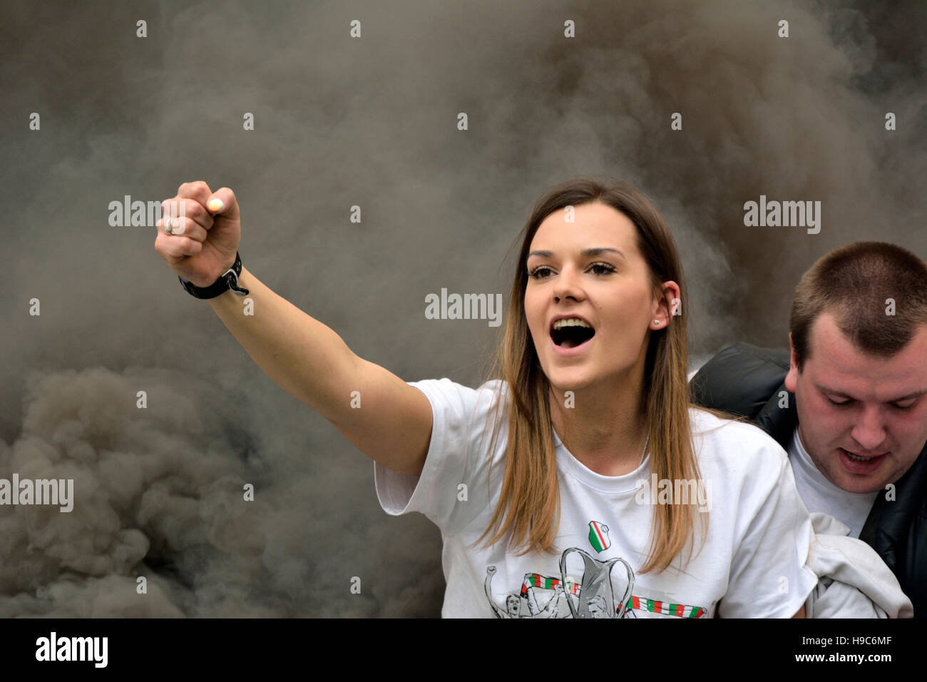 Legia Warsaw fan girl in a cloud of smoke at PGE Narodowy stadium in Warsaw Stock Photo