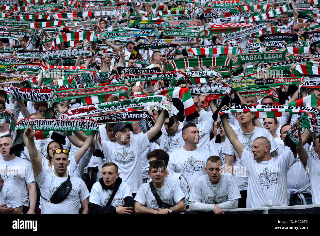 Legia Warsaw fans holding fan scarves at PGE Narodowy stadium in Warsaw Stock Photo