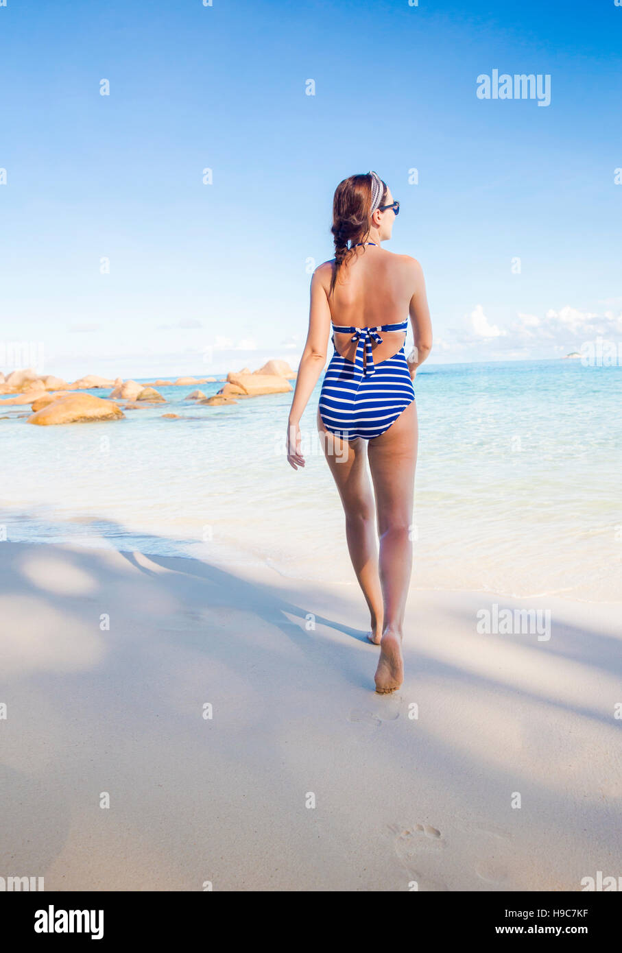 Beautiful woman enjoying the beautiful beachs of Praslin, Seychelles Stock Photo