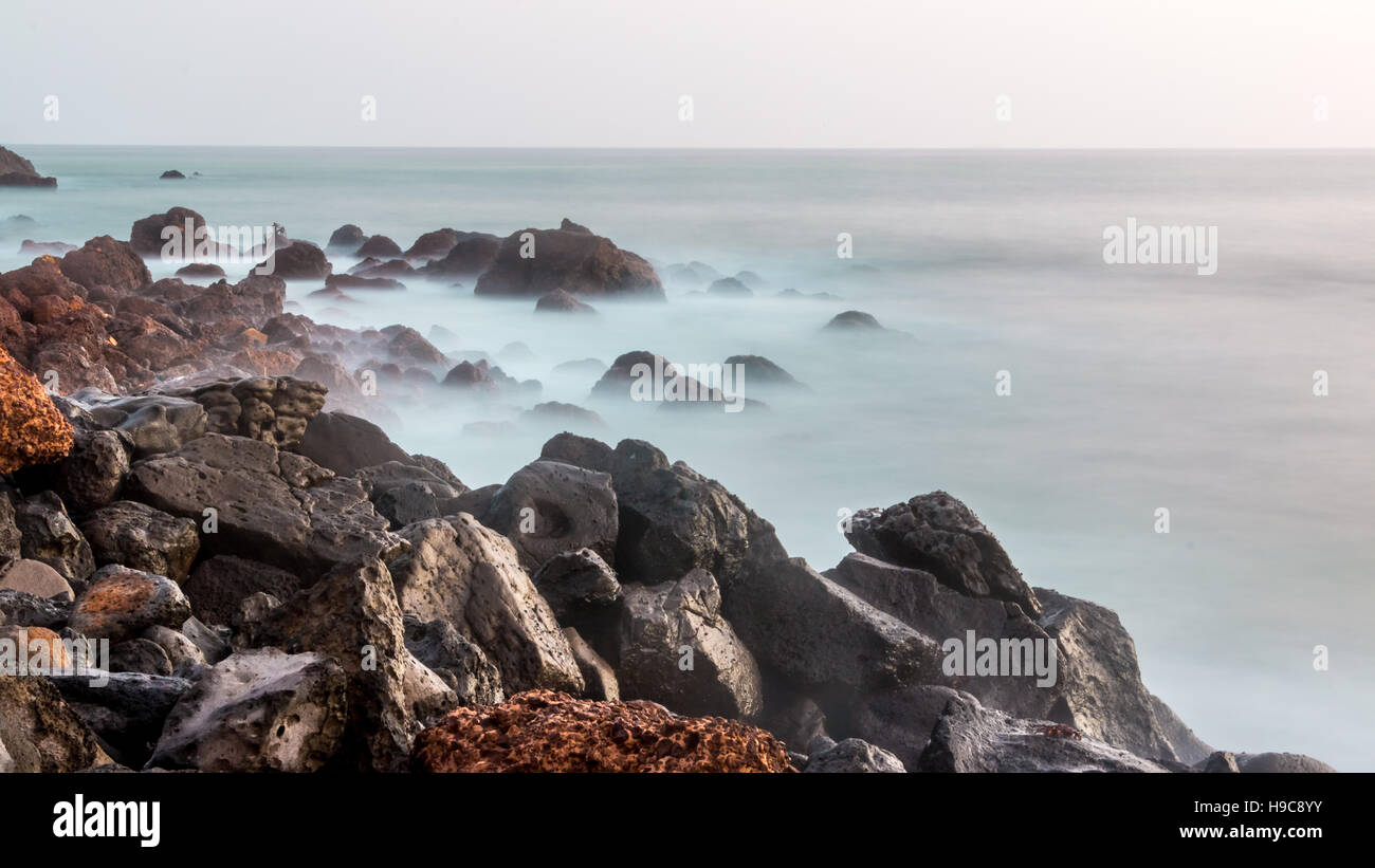 The beautiful waters of the Atlantic ocean with its rocky coastline near the City of Dakar in Senegal Stock Photo