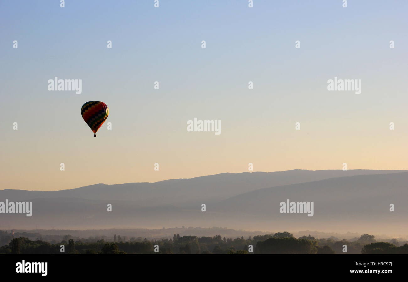 Hot air balloon in the morning mist over the fields of france Stock Photo