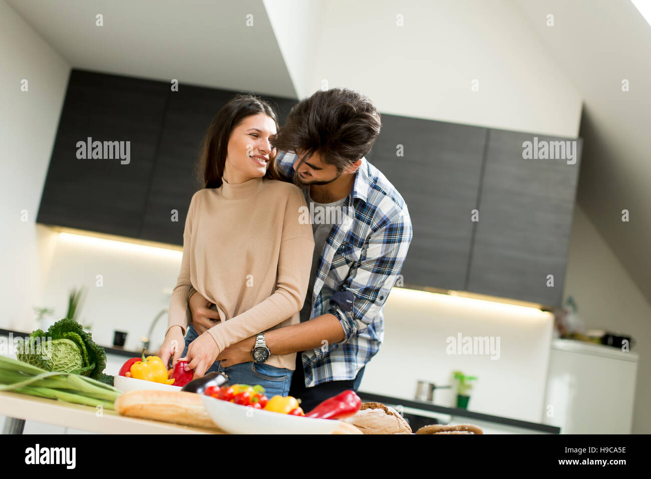 Young couple preparing food in the kitchen Stock Photo