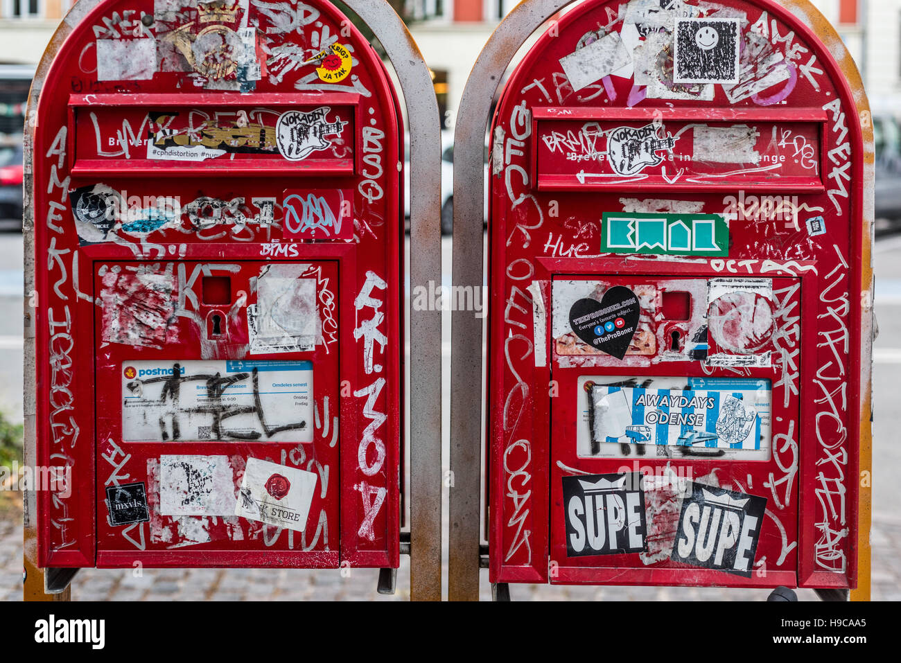 Graffiti and stickers cover two red post boxes in Copenhagen, Denmark Stock  Photo - Alamy