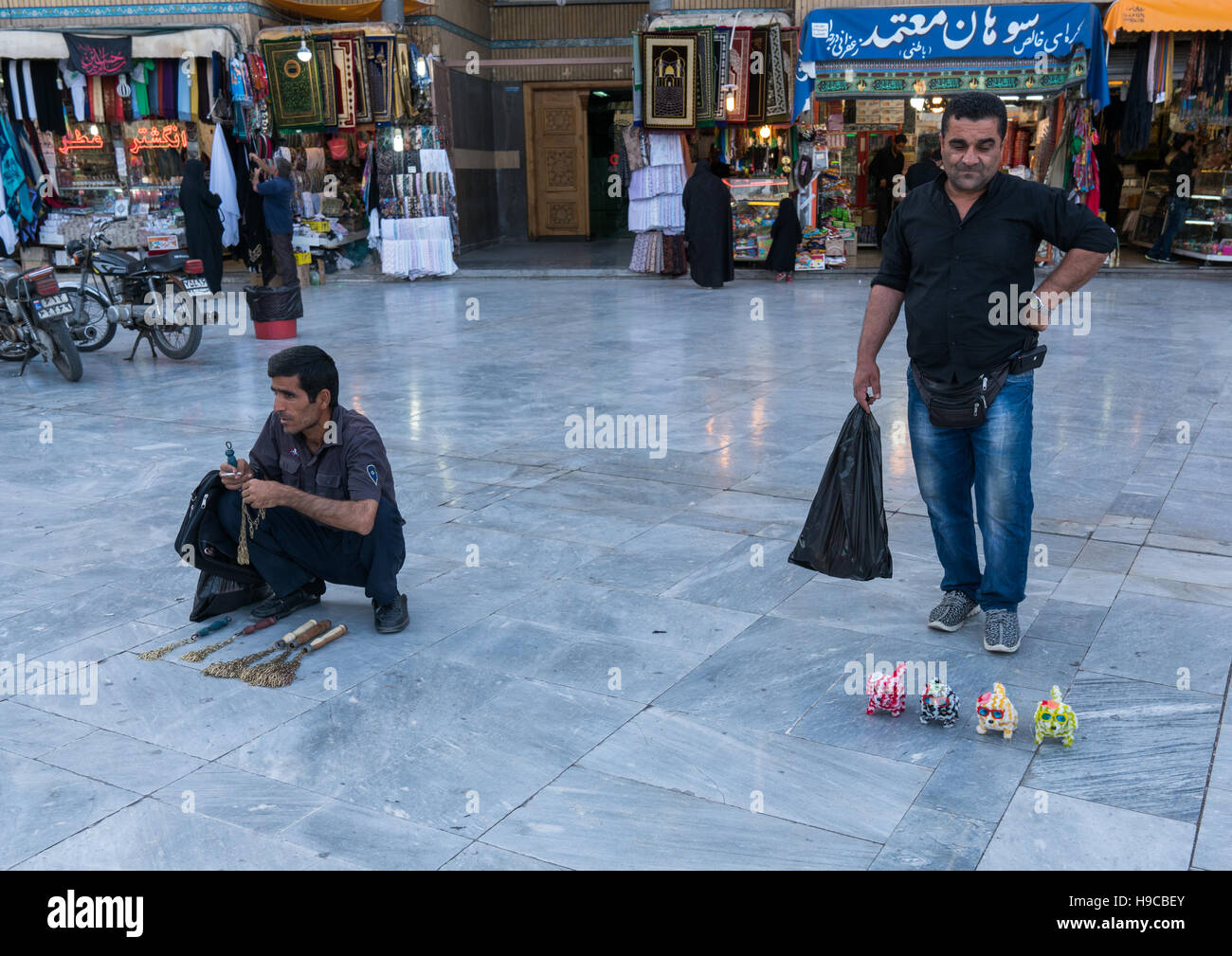 Men selling iron chains for children and toys  in fatima al-masumeh shrine during muharram, Central county, Qom, Iran Stock Photo