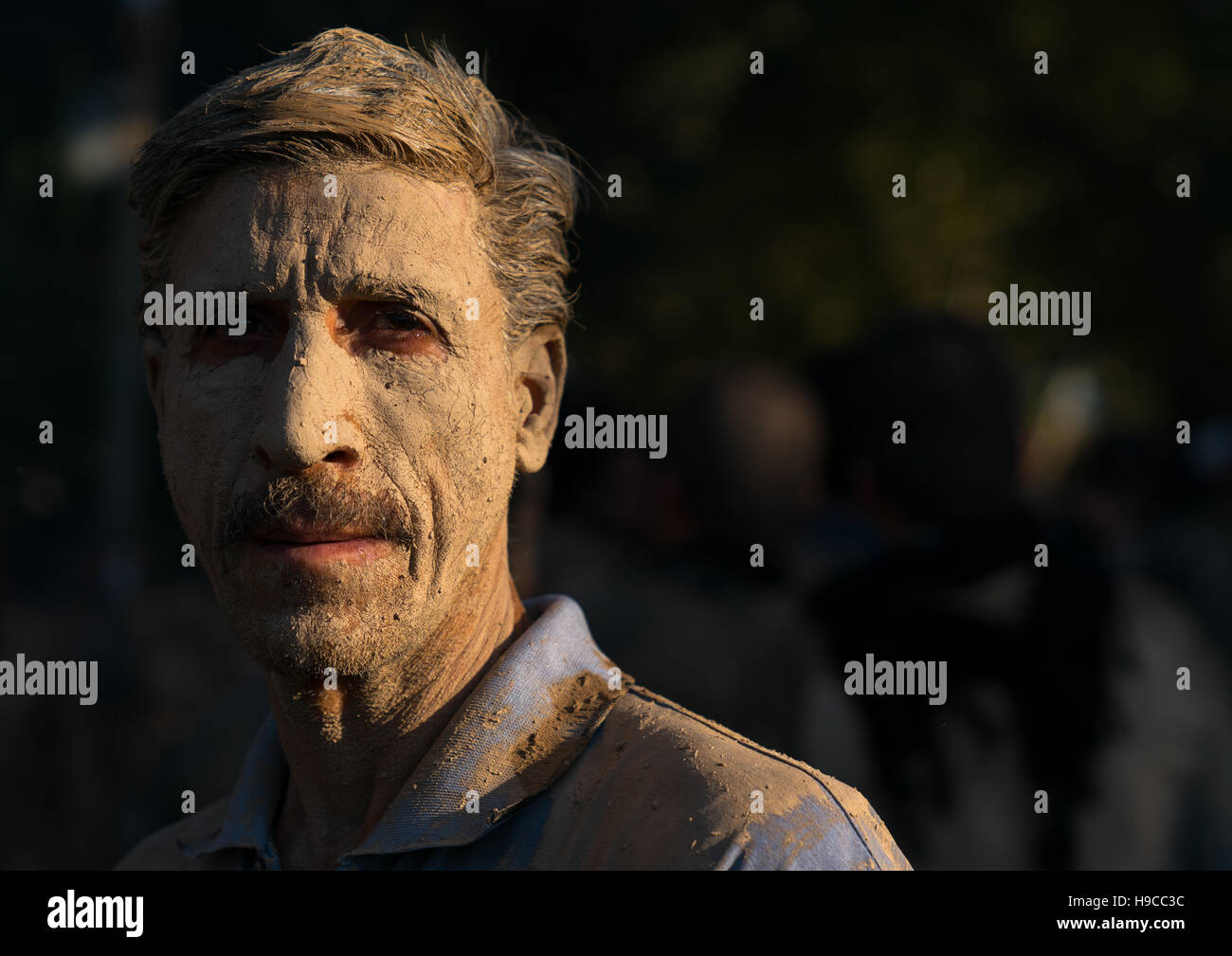 Iranian shiite muslim man after rubbing mud on his body during the