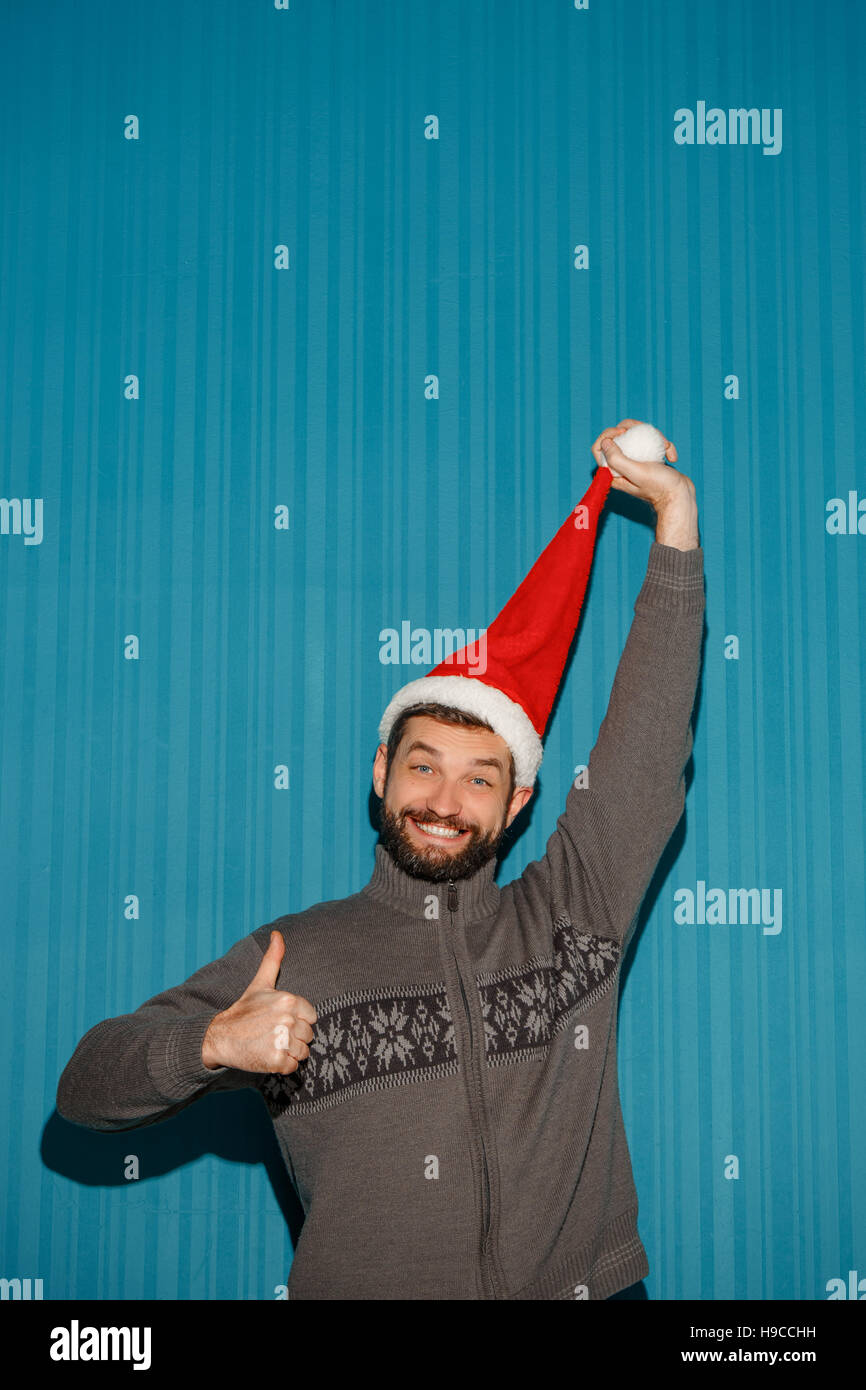 Smiling christmas man wearing a santa hat Stock Photo Alamy