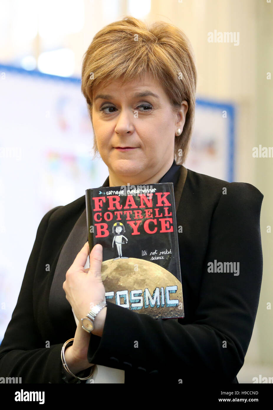 First Minister Nicola Sturgeon holding a copy of Frank Cottrell Boyce's Cosmic during a visit to St Conval's Primary School in Glasgow to meet children participating in the First Minister's Reading Challenge on the first day of Book Week Scotland. Stock Photo